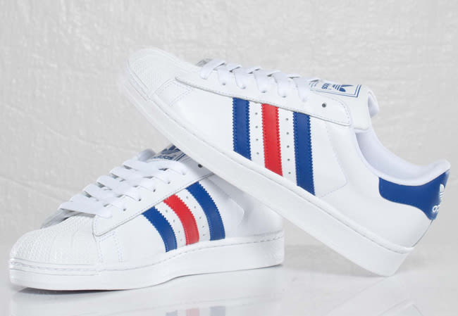 white adidas with red and blue stripes