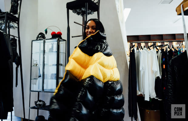 Aleali May trying on a coat at H. Lorenzo in West Hollywood, Calif.