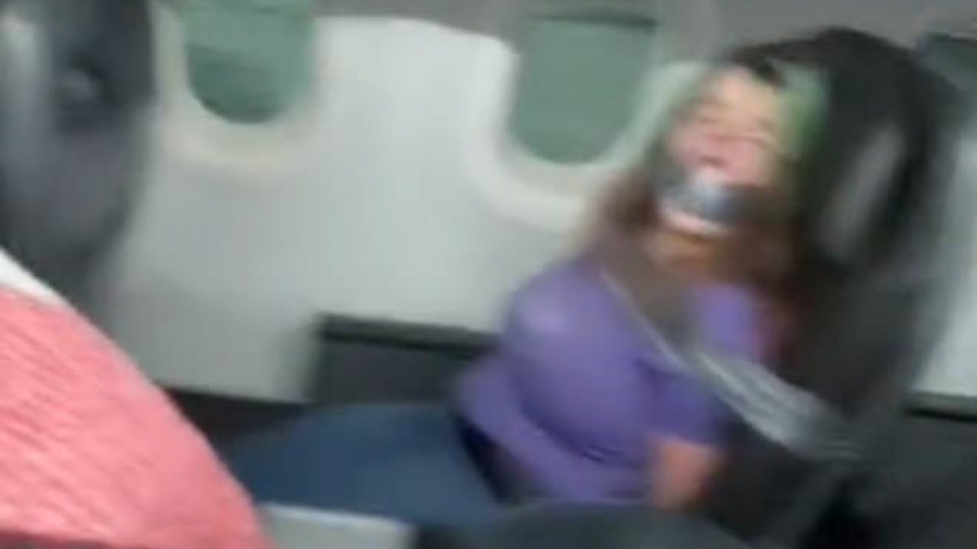 Woman Duct-Taped to Plane Seat After Attempting to Open Plane Door During  Apparent Mental Breakdown