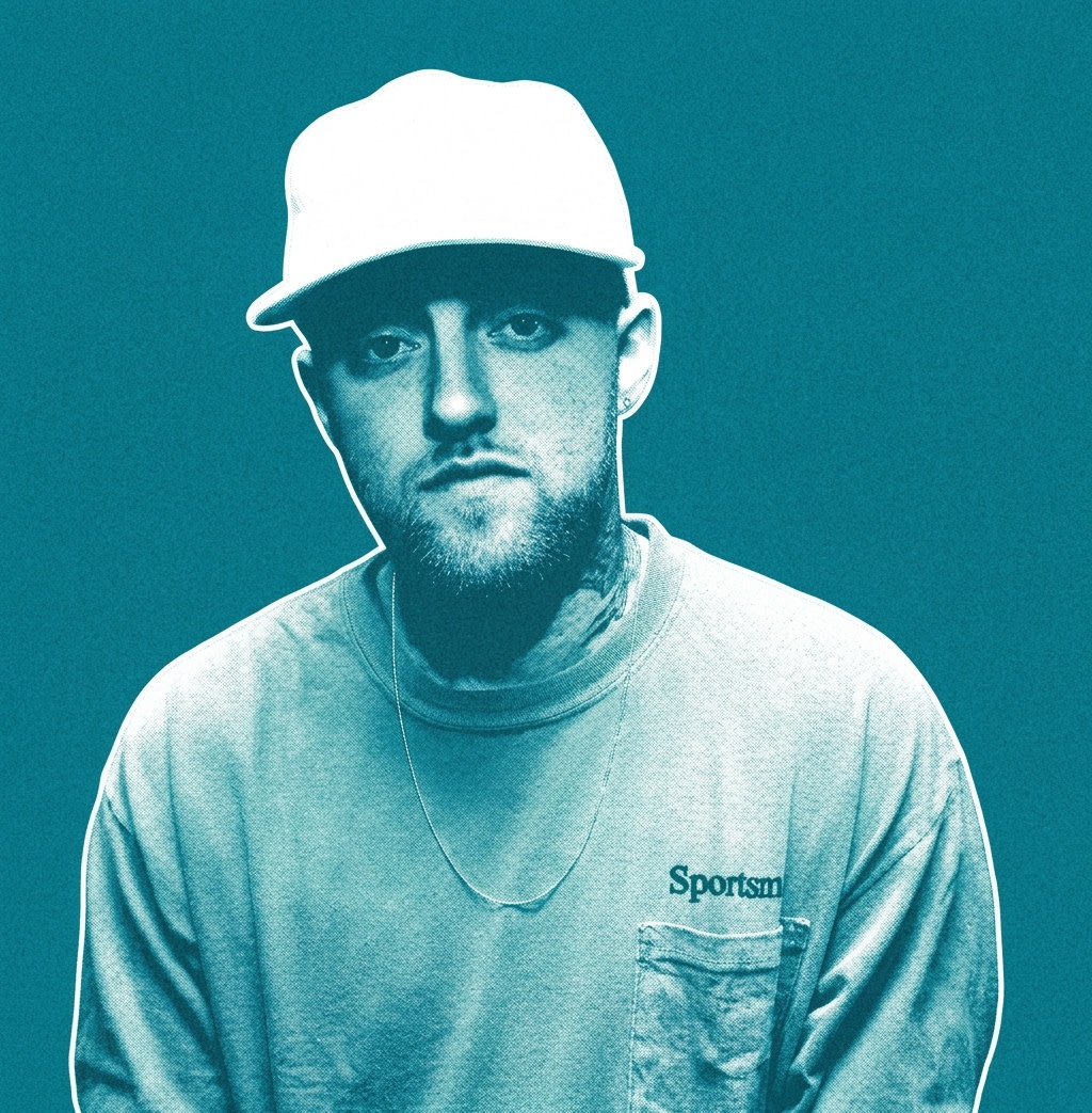Mac Miller in a white cap and pink sweatshirt stands against a red curtain backdrop.