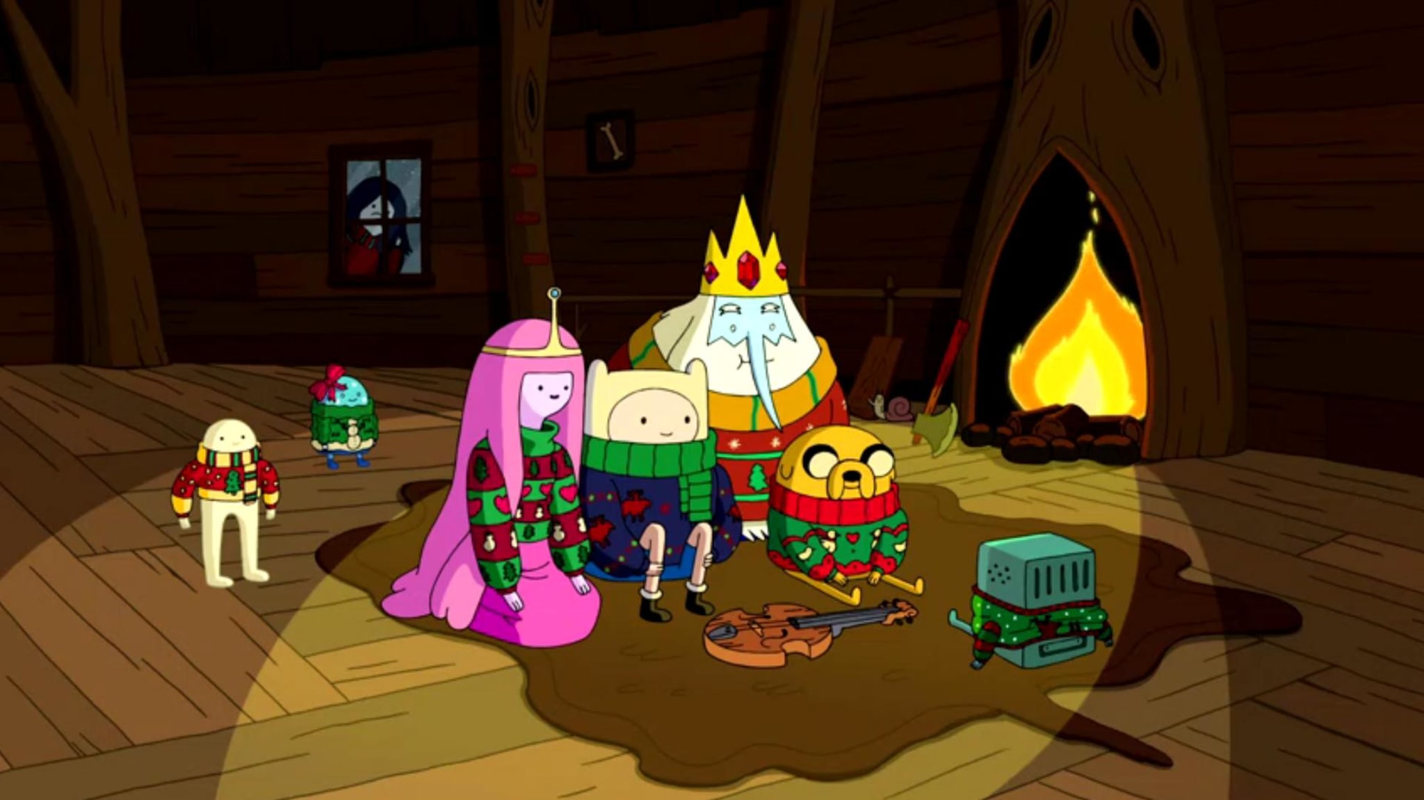 Animated characters from 'Adventure Time' wearing holiday sweaters, sitting by a fireplace.