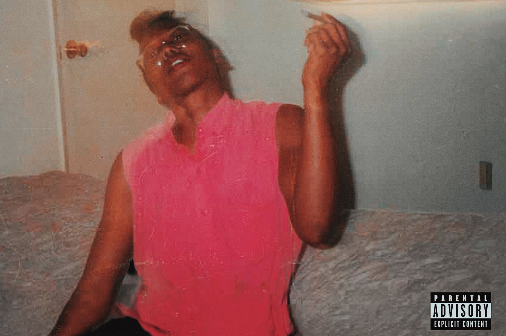 Album cover of a person in a pink shirt sits on a bed, holding a cigarette. The room has a door and a window with a shade. Explicit content label.