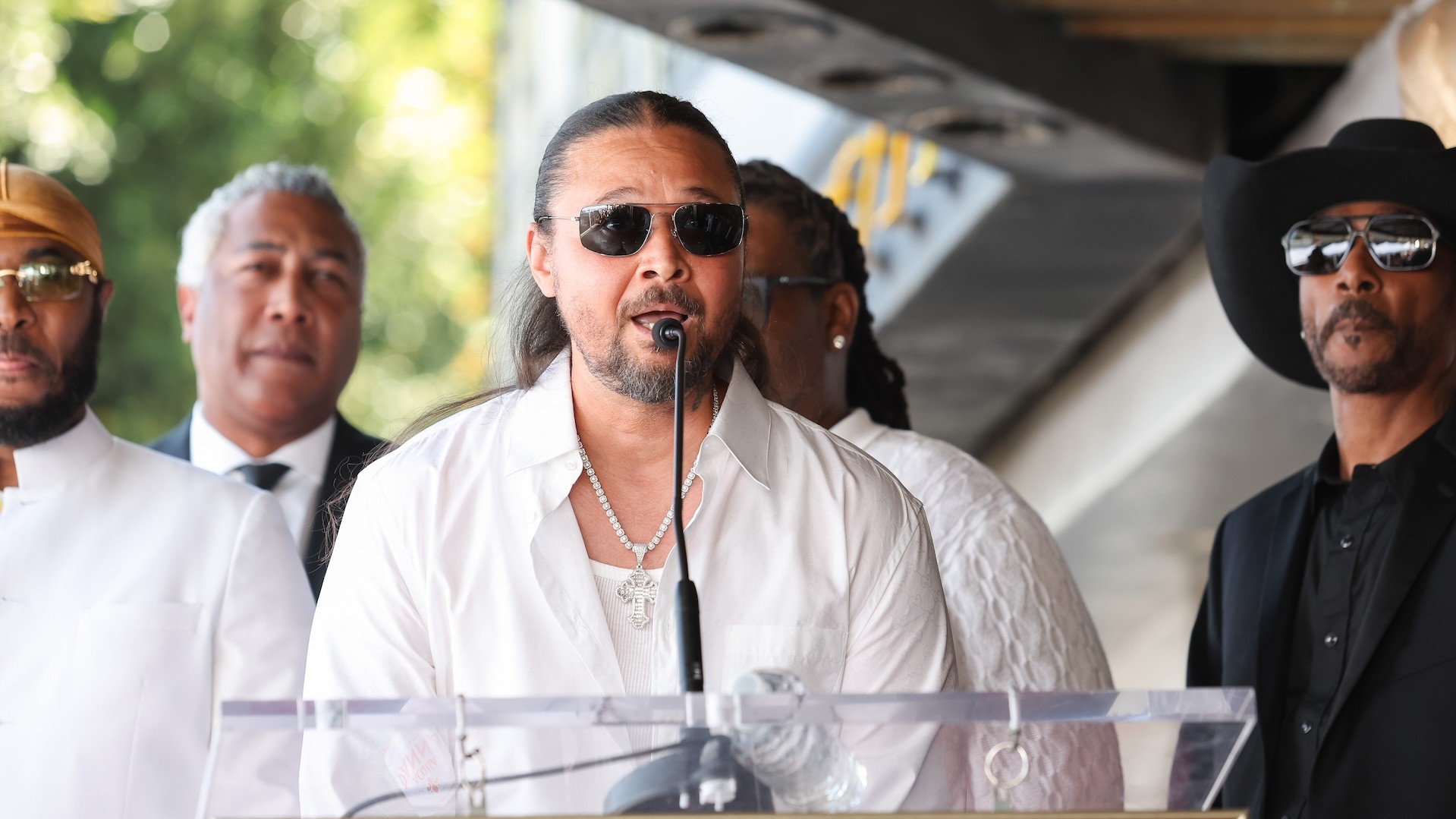 Bizzy Bone of Bone Thugs-N-Harmony speaks onstage as they are honored with a star on the Hollywood Walk of Fame.
