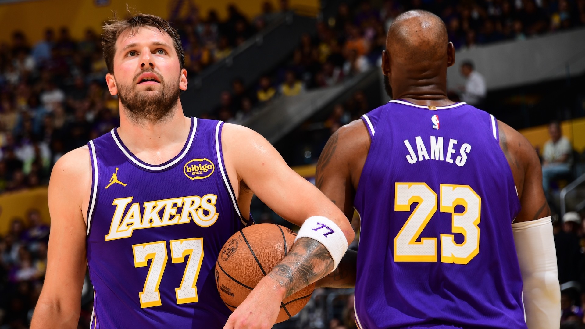 Luka Doncic and LeBron James of the Los Angeles Lakers look on during the game.