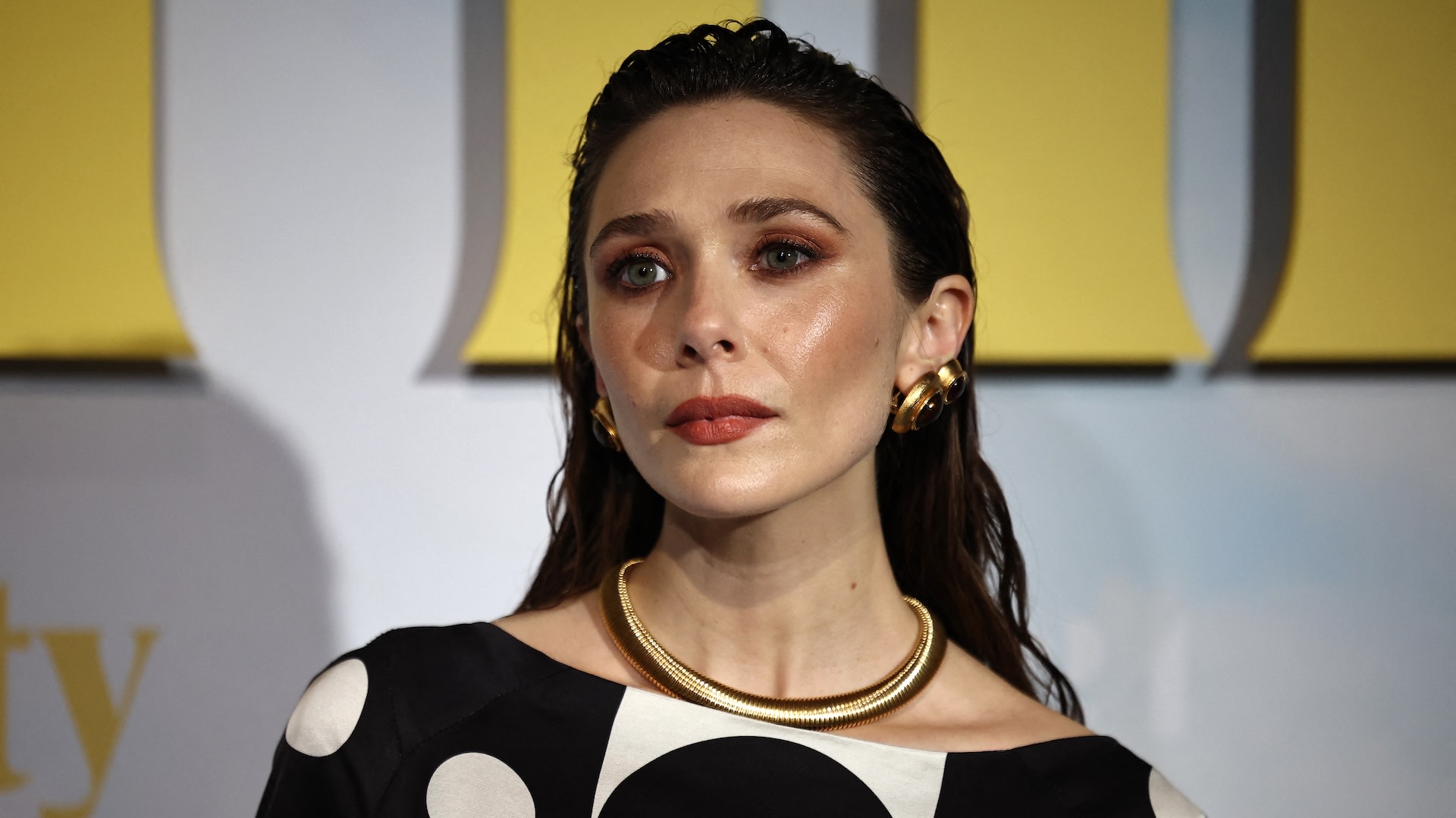 TOPSHOT - US actor Elizabeth Olsen poses on the red carpet on arrival for the UK Premiere of "Eternity" at The Cinema in the Power Station in London on November 17, 2025.
