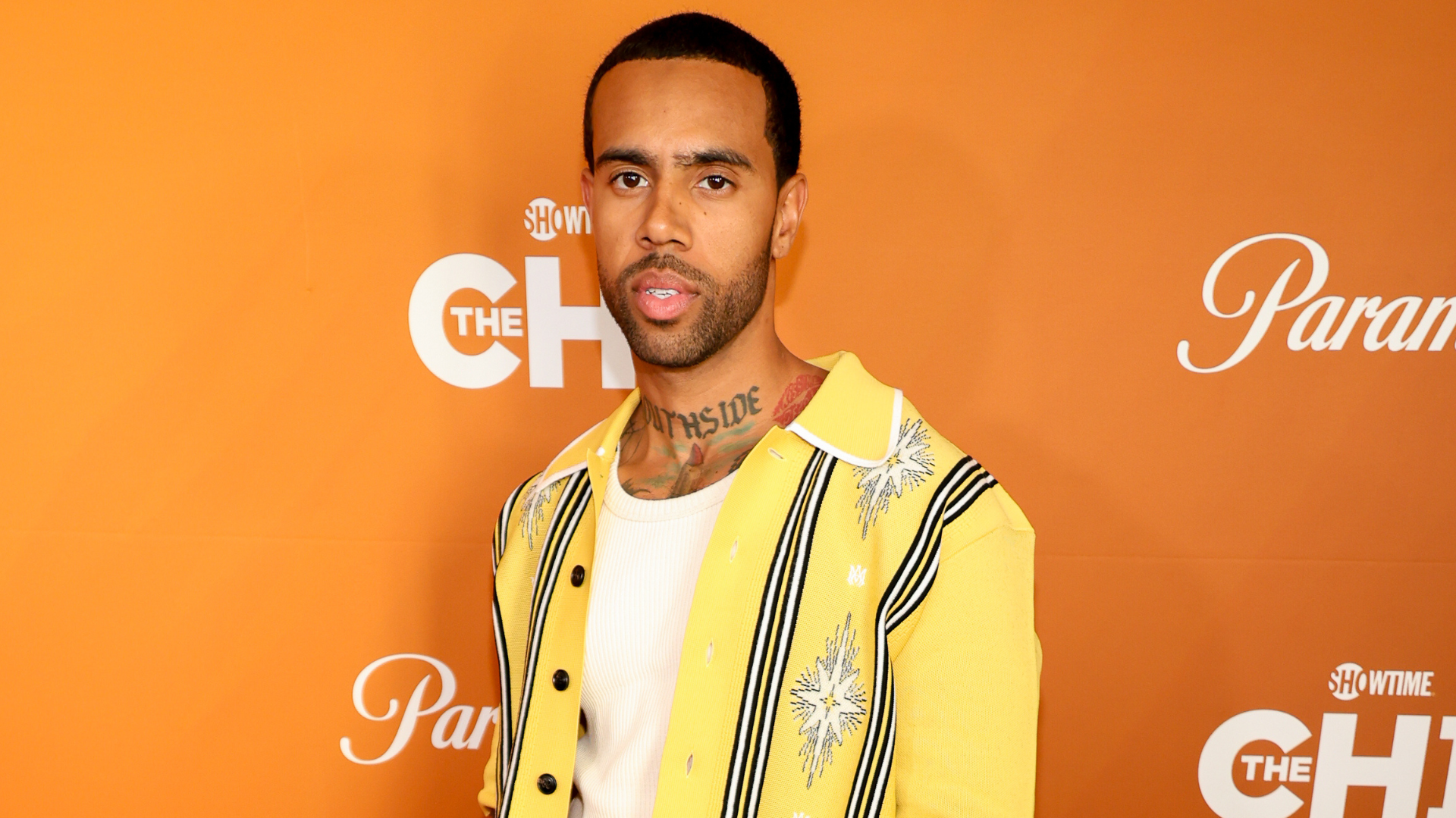A man in a yellow patterned shirt stands against an orange backdrop with "Showtime" and "The Chi" logos.