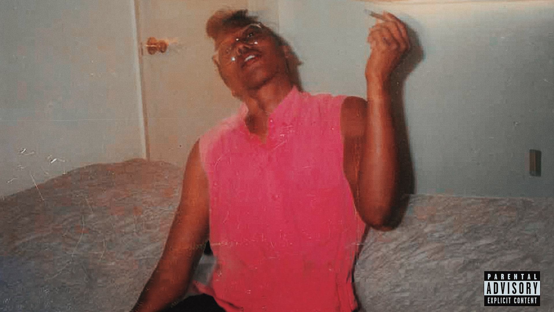 Album cover of a person in a pink shirt sits on a bed, holding a cigarette. The room has a door and a window with a shade. Explicit content label.