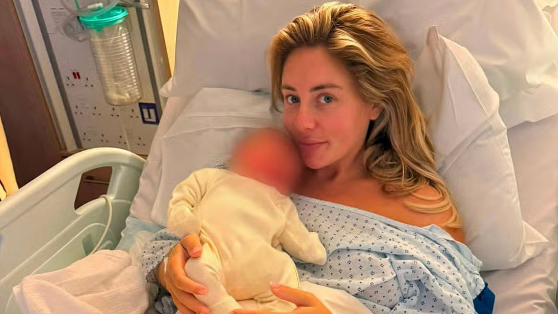 Bonnie Blue in a hospital bed holding a newborn wrapped in a white outfit. The setting is a hospital room.