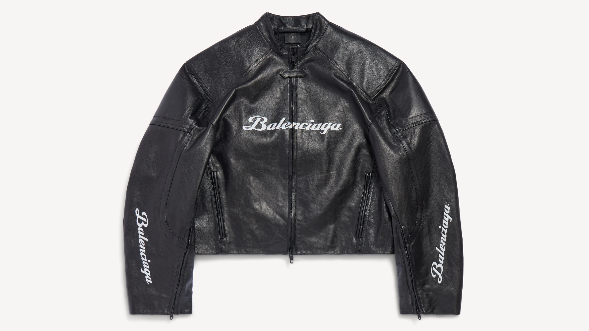 A black leather Balenciaga jacket with white logos on the chest and sleeves.