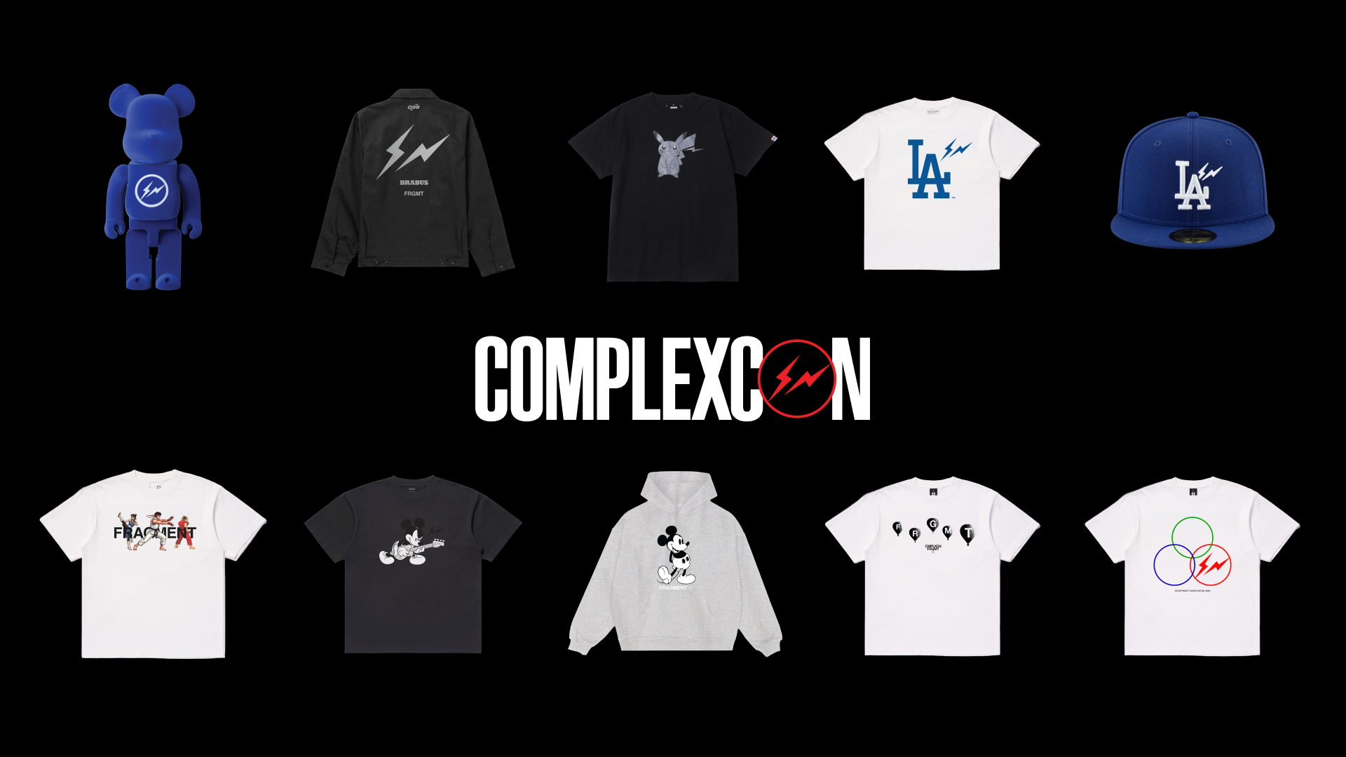 Text "COMPLEXCON" on a textured, metallic rock surface with a lightning bolt in the letter "O," set against a black background.