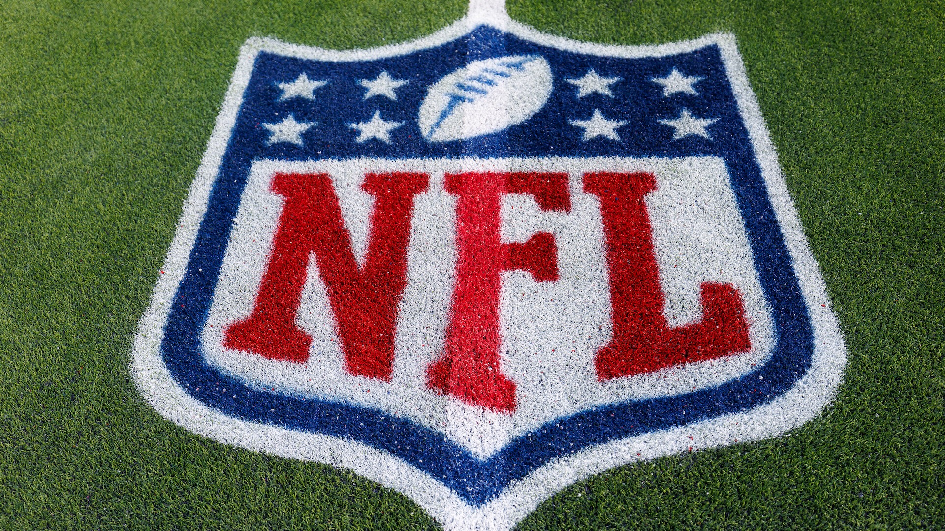 A detail view of the NFL shield logo painted on the turf in SoFi Stadium.