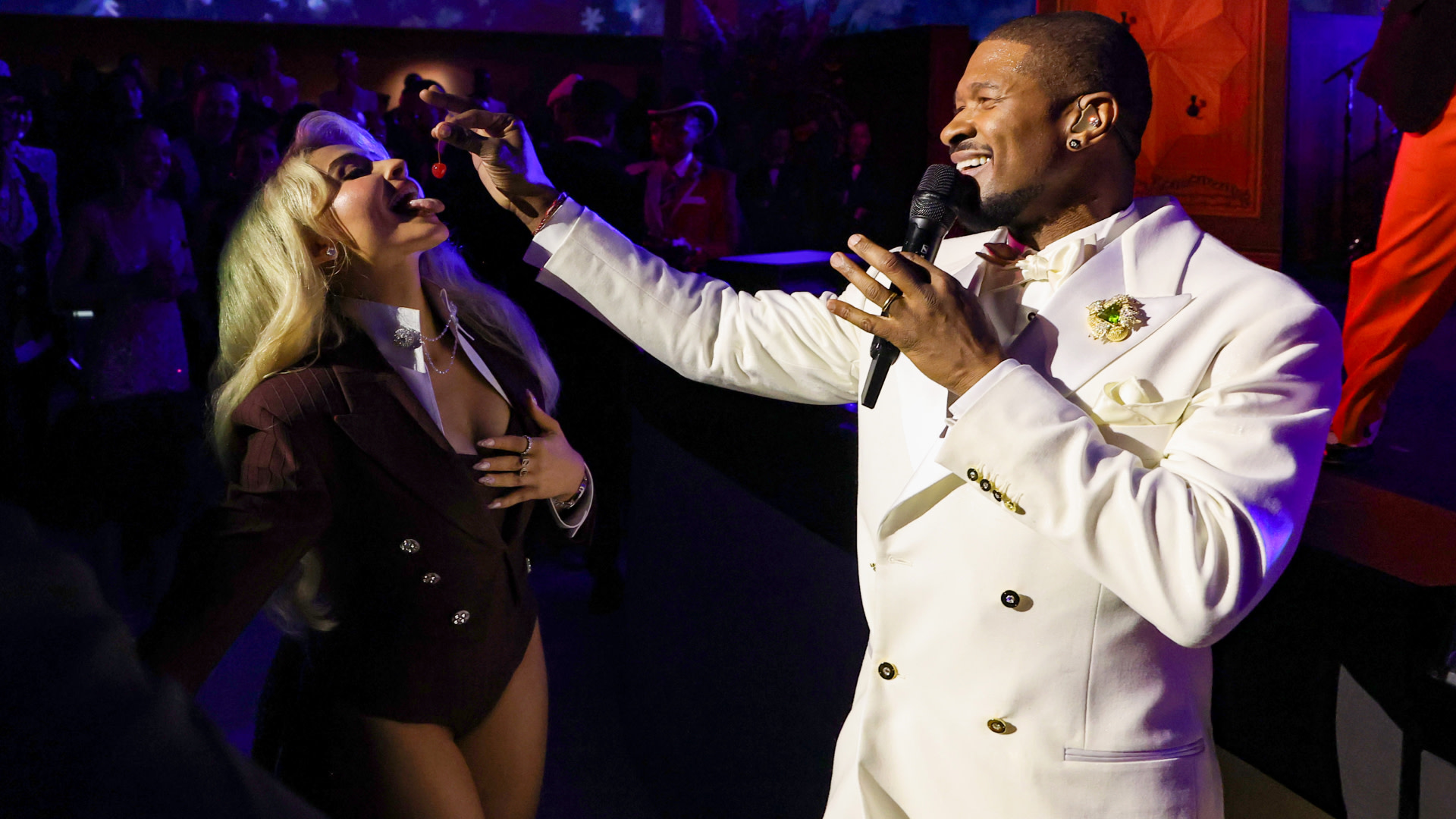Sabrina Carpenter eats a cherry out of Usher's hand at the Met Gala.