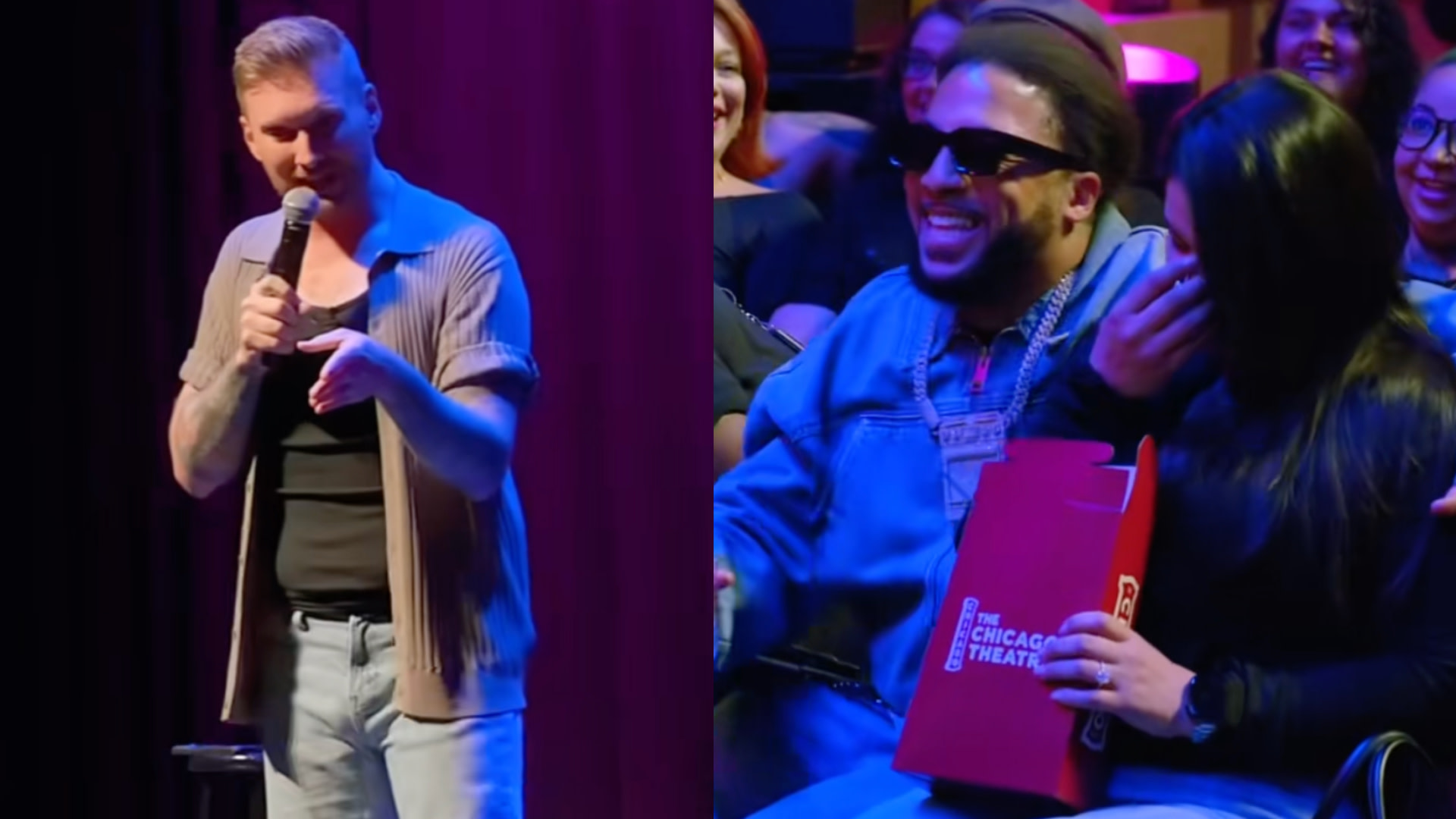 A comedian performs on stage with a microphone. In the audience, a man in sunglasses and a denim jacket laughs with a woman.