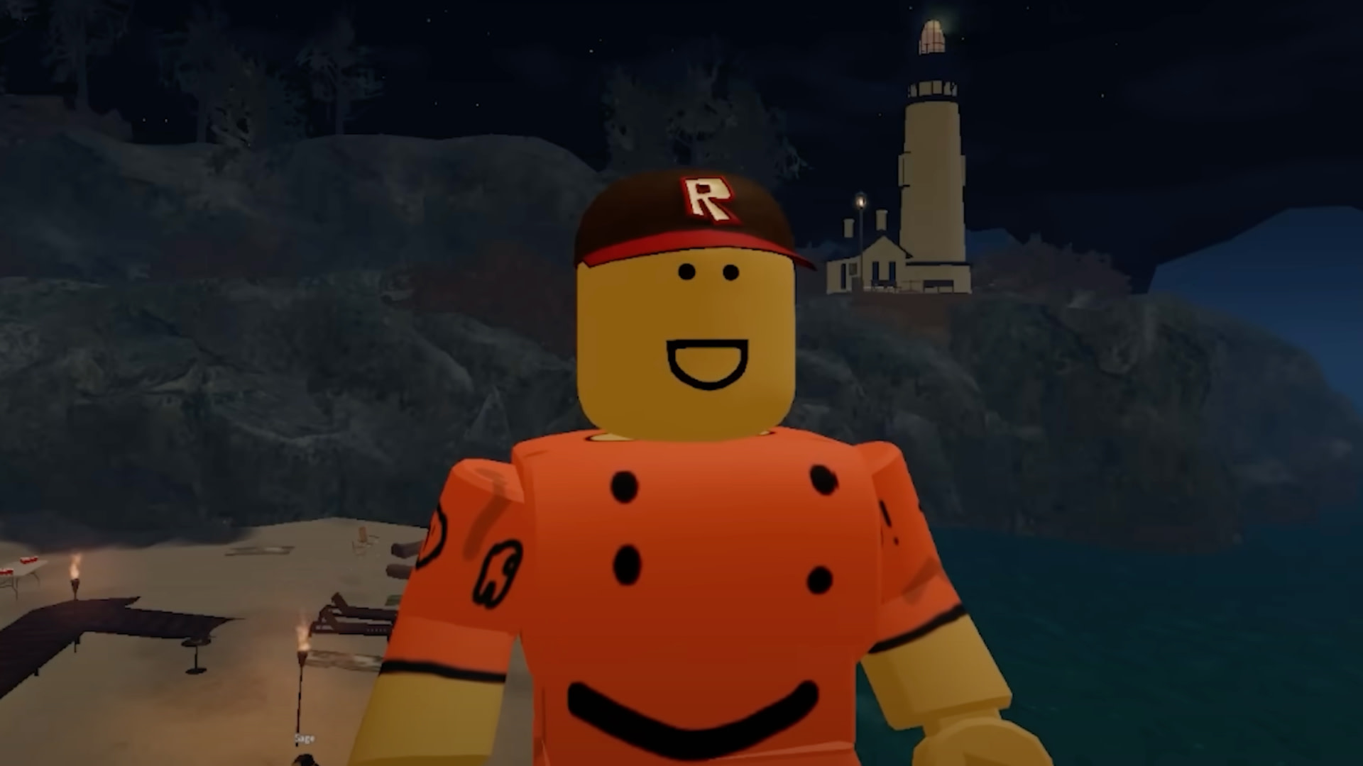 A Roblox character in an orange outfit and cap stands near a lighthouse at night.
