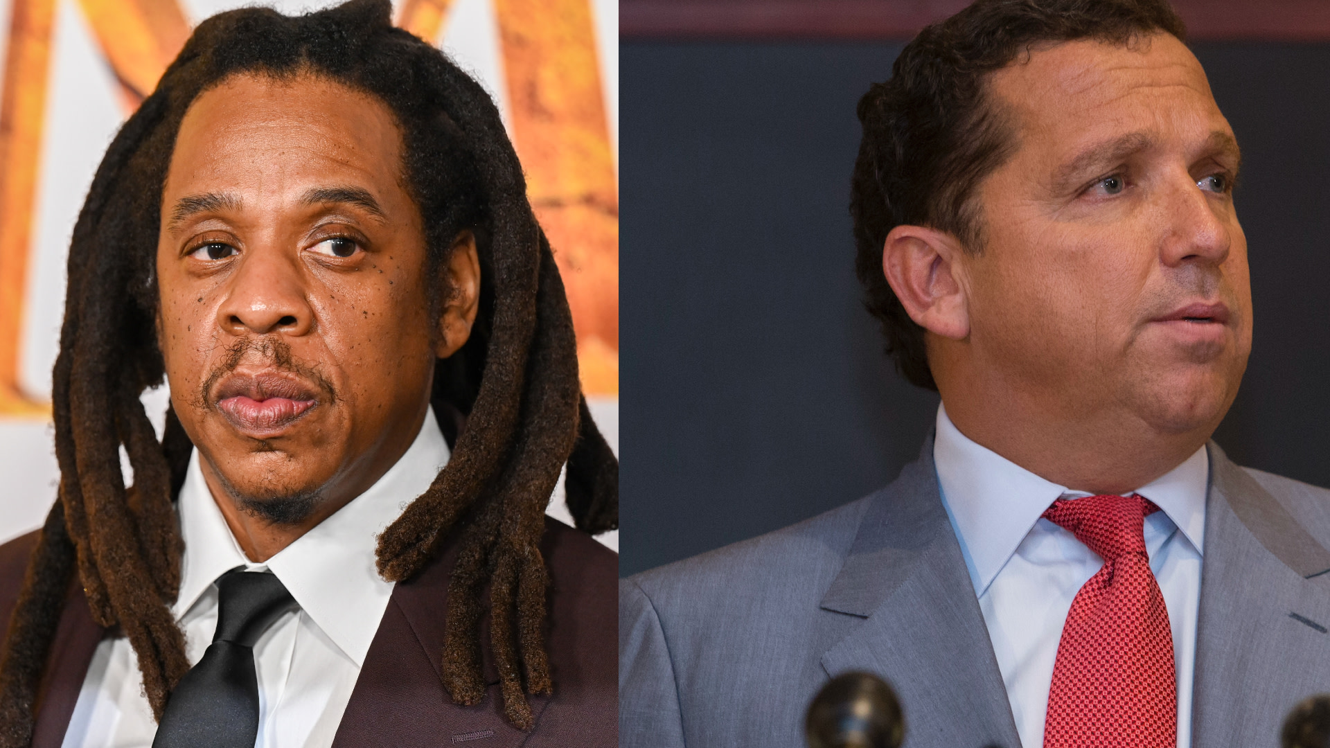 Jay-Z on the left, wearing a suit and tie, and lawyer on the right, also in a suit and tie, in a formal setting.