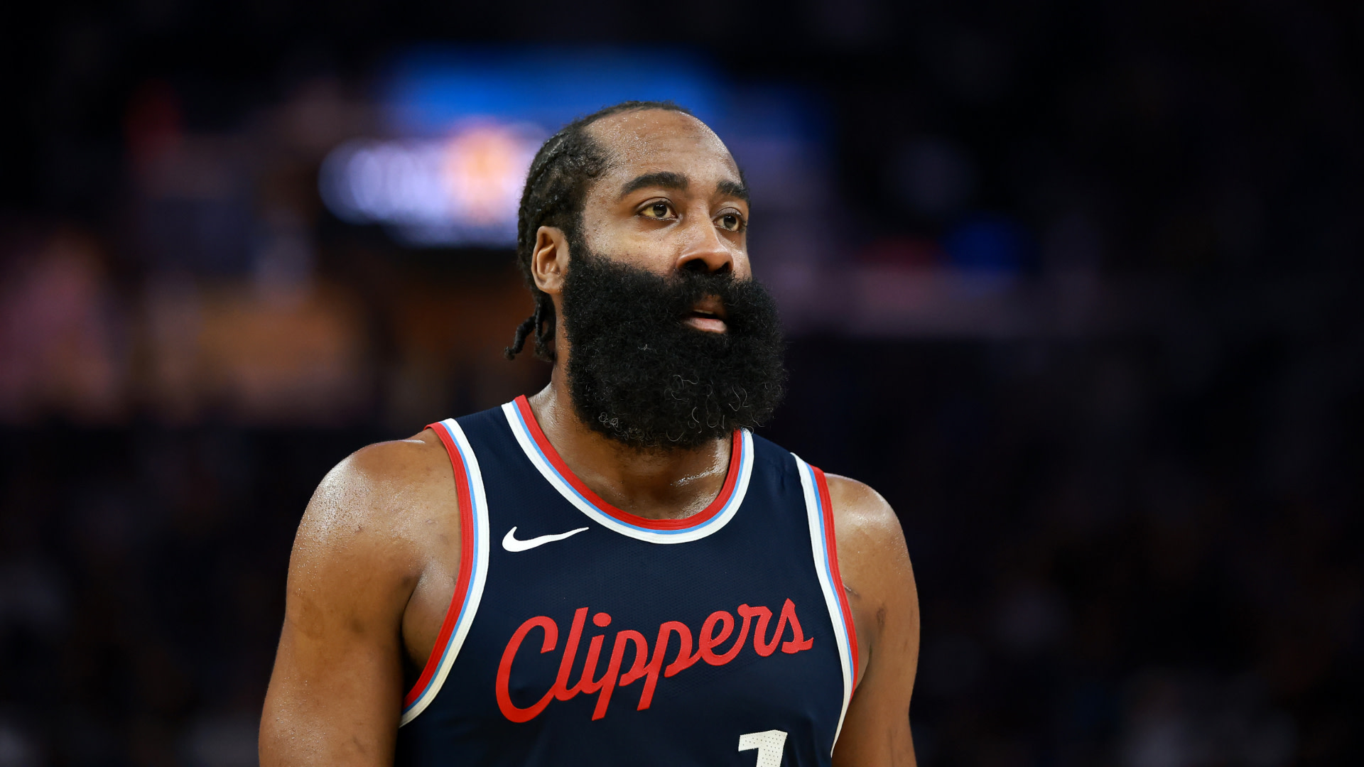 James Harden with a beard wearing a Clippers jersey on the court.