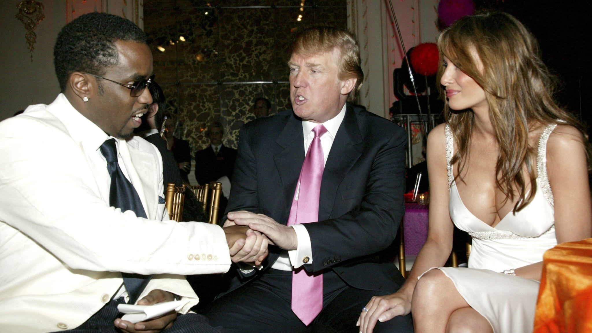 Sean Combs, Donald Trump, and Melania Trump at an event, with Combs and Trump shaking hands.