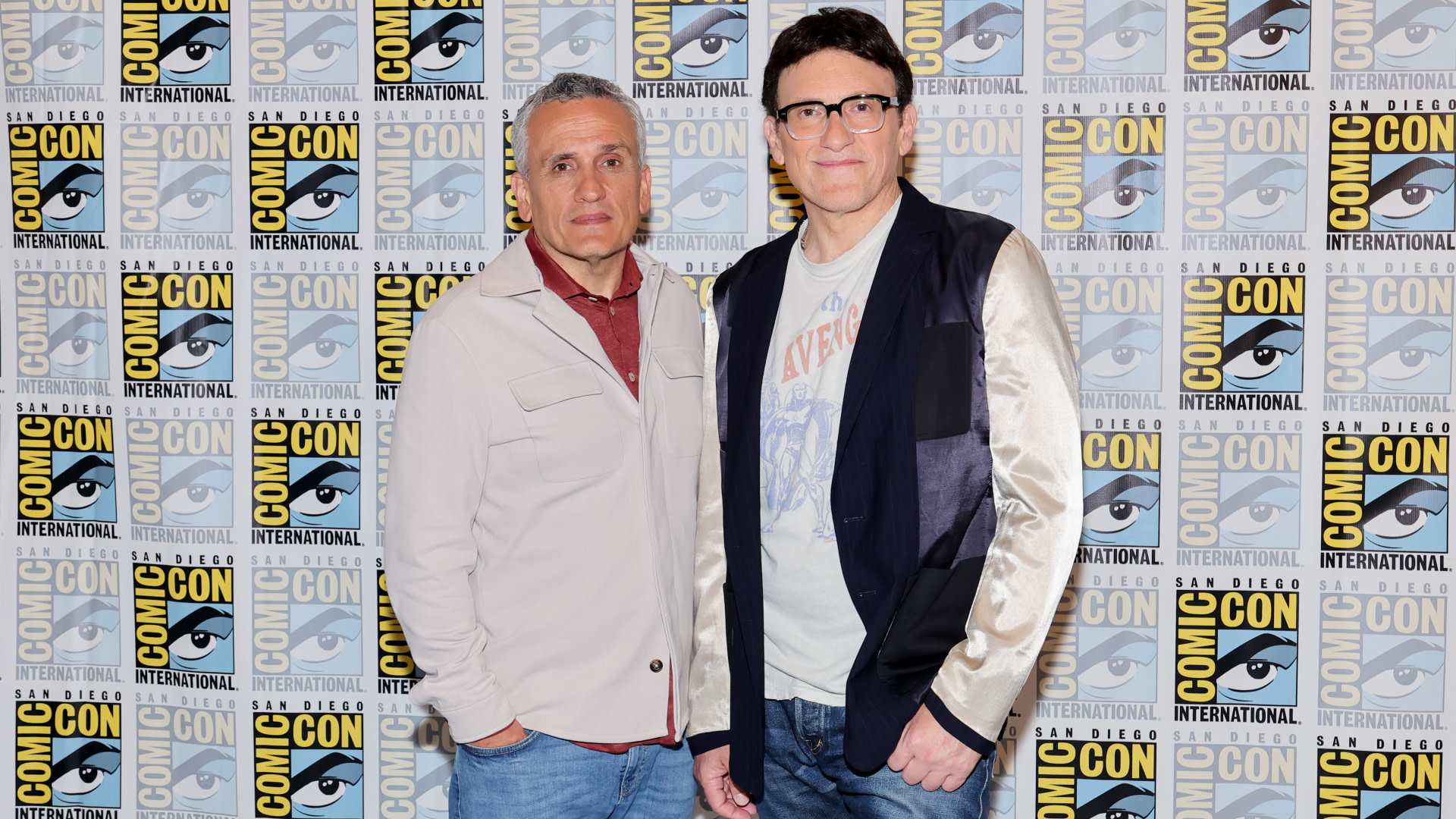 Russos pose at Comic-Con International. The background features the event's logo.
