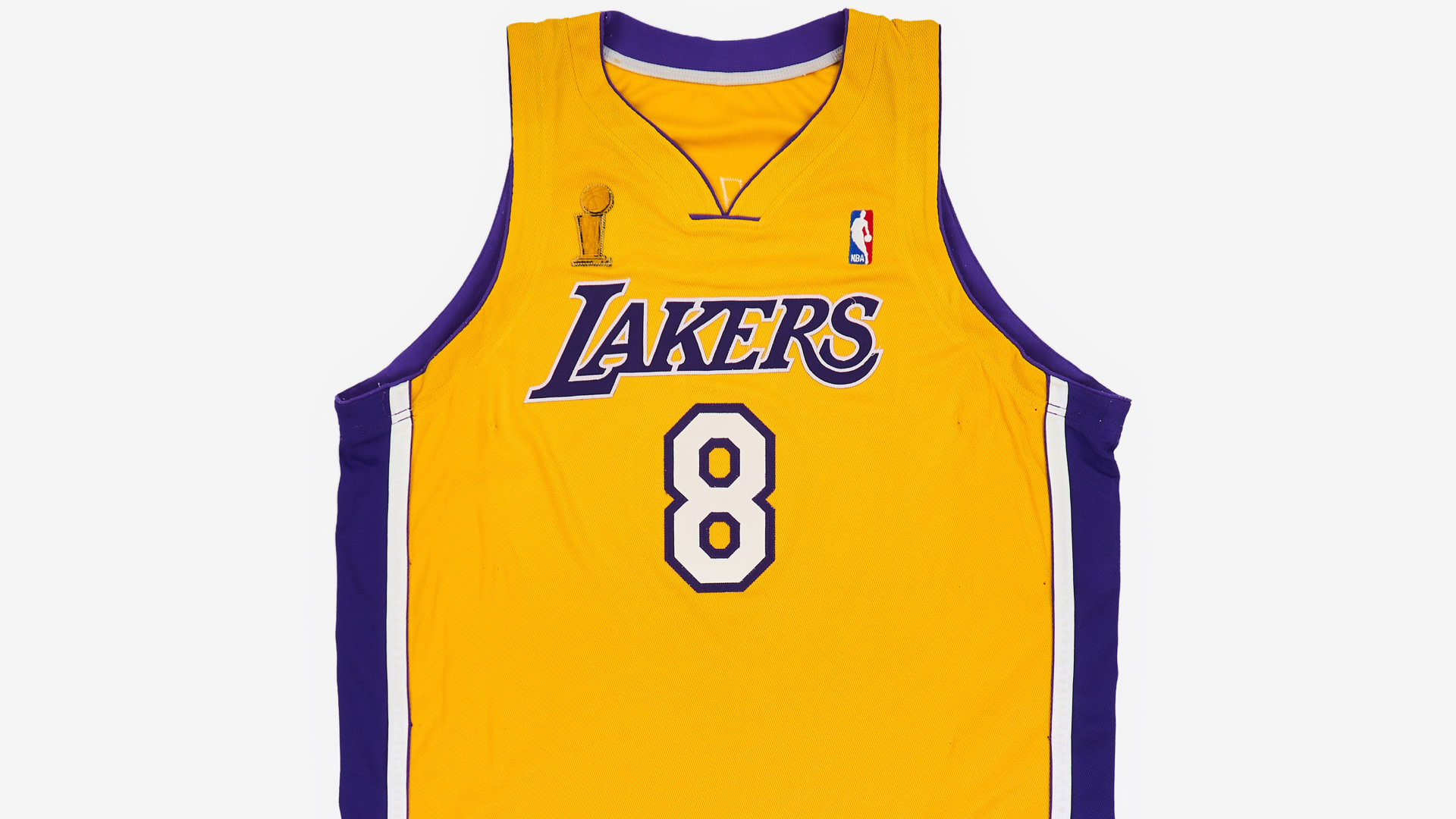 Yellow Los Angeles Lakers jersey with number 8, associated with Kobe Bryant. Features NBA and championship logos.