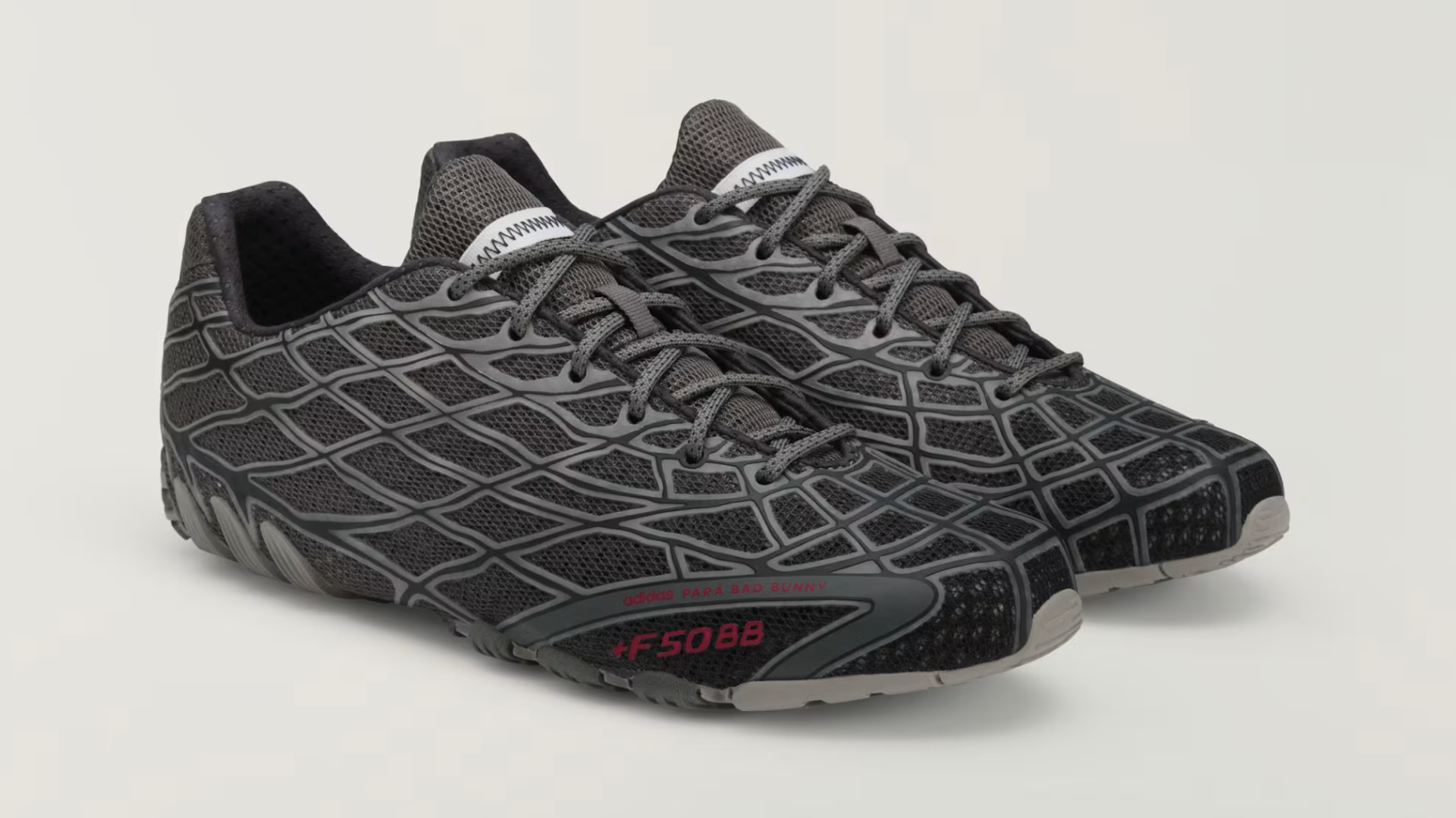 A pair of black and gray athletic shoes with a textured, net-like design and red "F5088" text on the side.