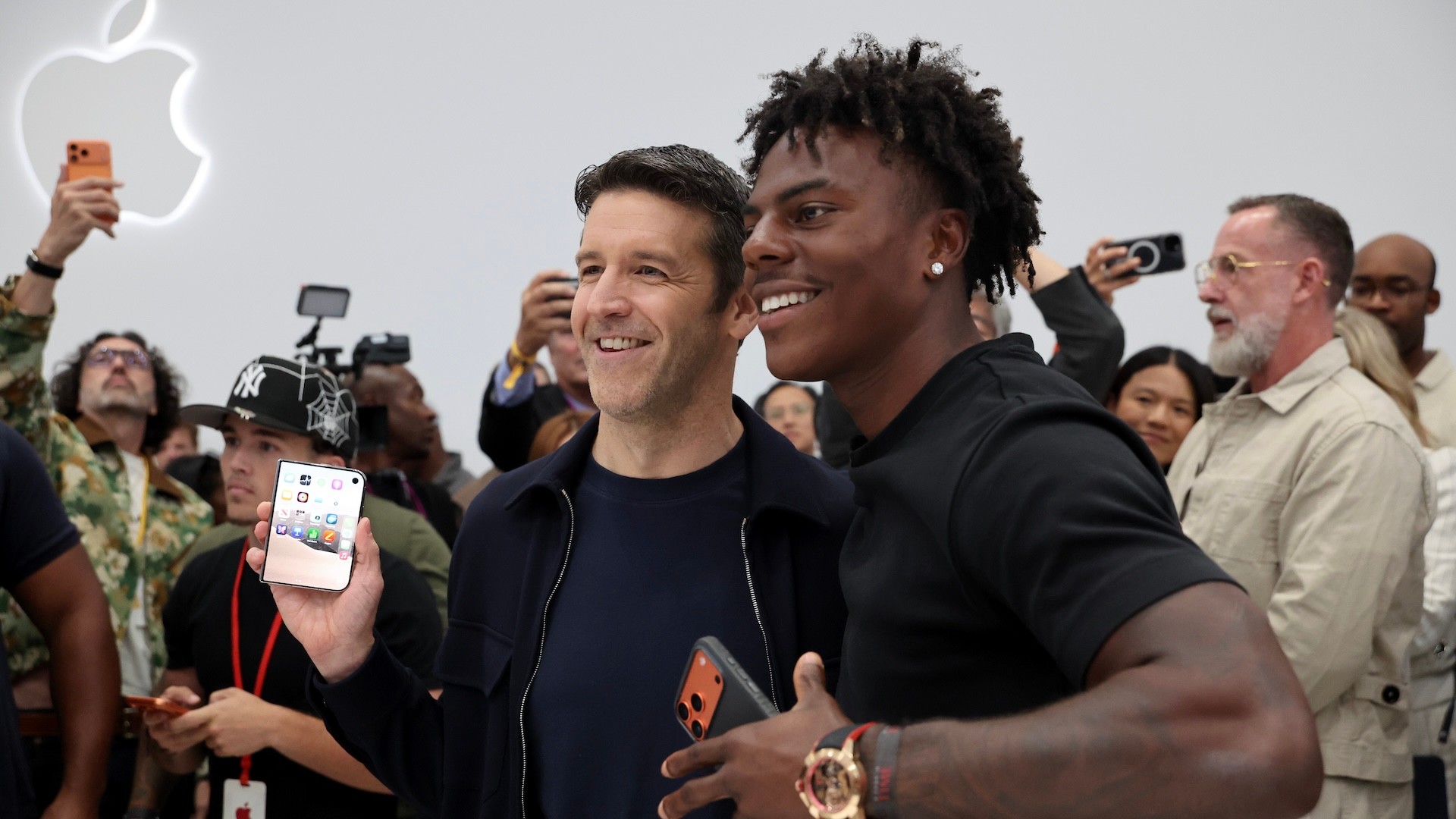 CUPERTINO, CALIFORNIA - SEPTEMBER 09: Apple CEO John Ternus (L) stands with Darren Jason Watkins Jr., "IShowSpeed", as he holds the new iPhone Duo during Apple’s “Surprise and Shine” event at the company's corporate headquarters, Apple Park, on September 9, 2026 in Cupertino, California.