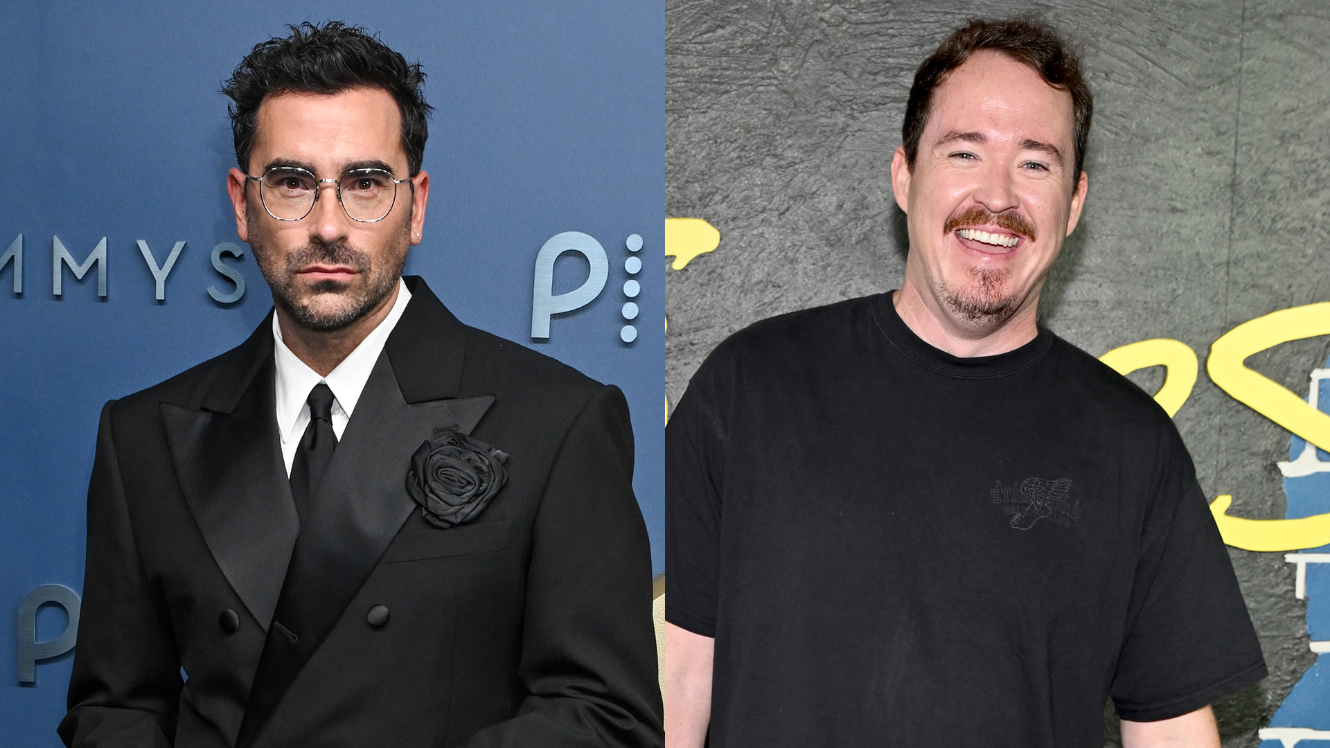 Dan Levy and Shane Gillis are pictured side by side. Dan Levy, left, wears a black suit with a floral lapel, while Shane Gillis, right, wears a black t-shirt and smiles.