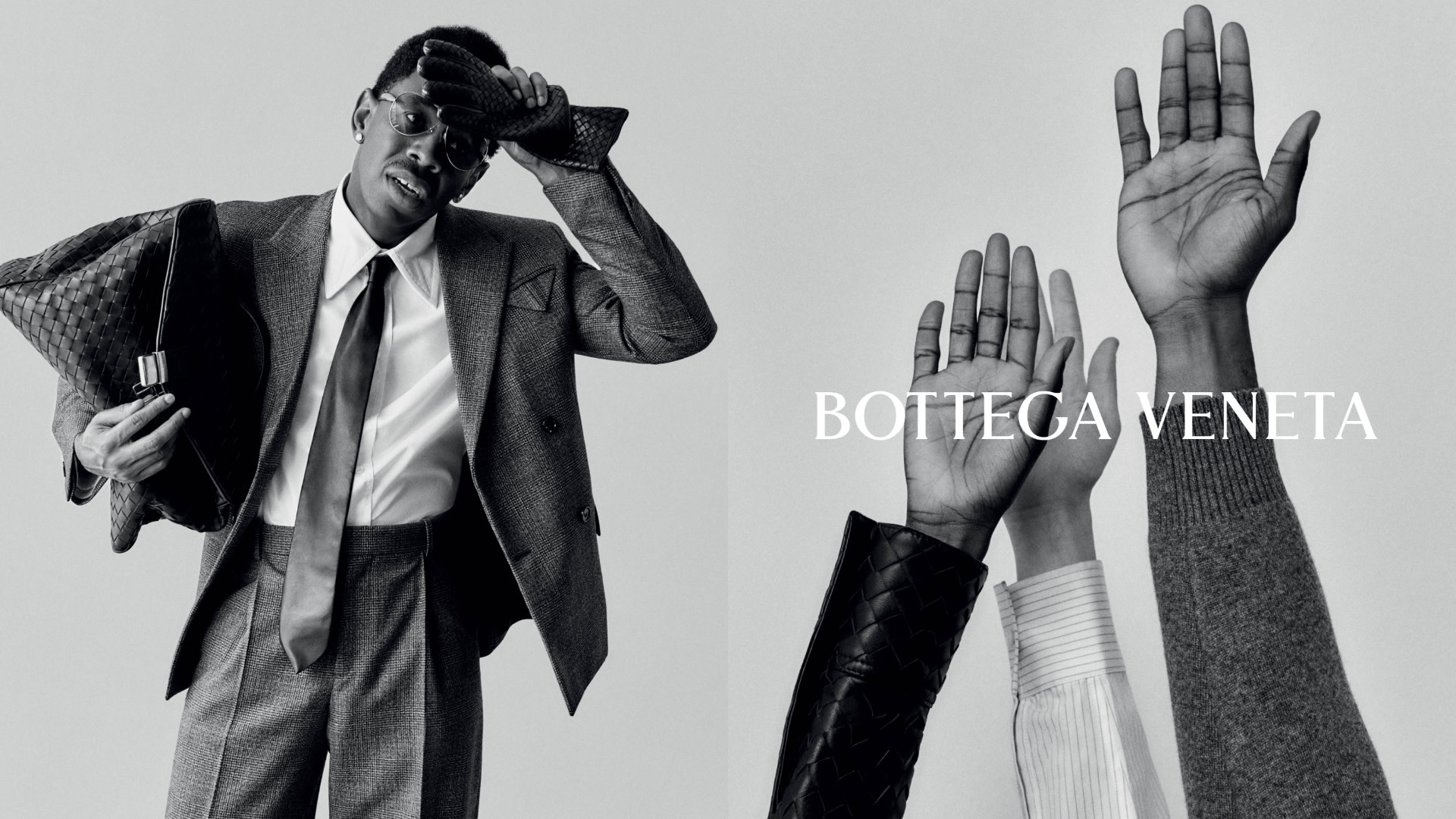 A stylish man in a suit with sunglasses and a bag, alongside raised hands, with "Bottega Veneta" text. Black and white image.