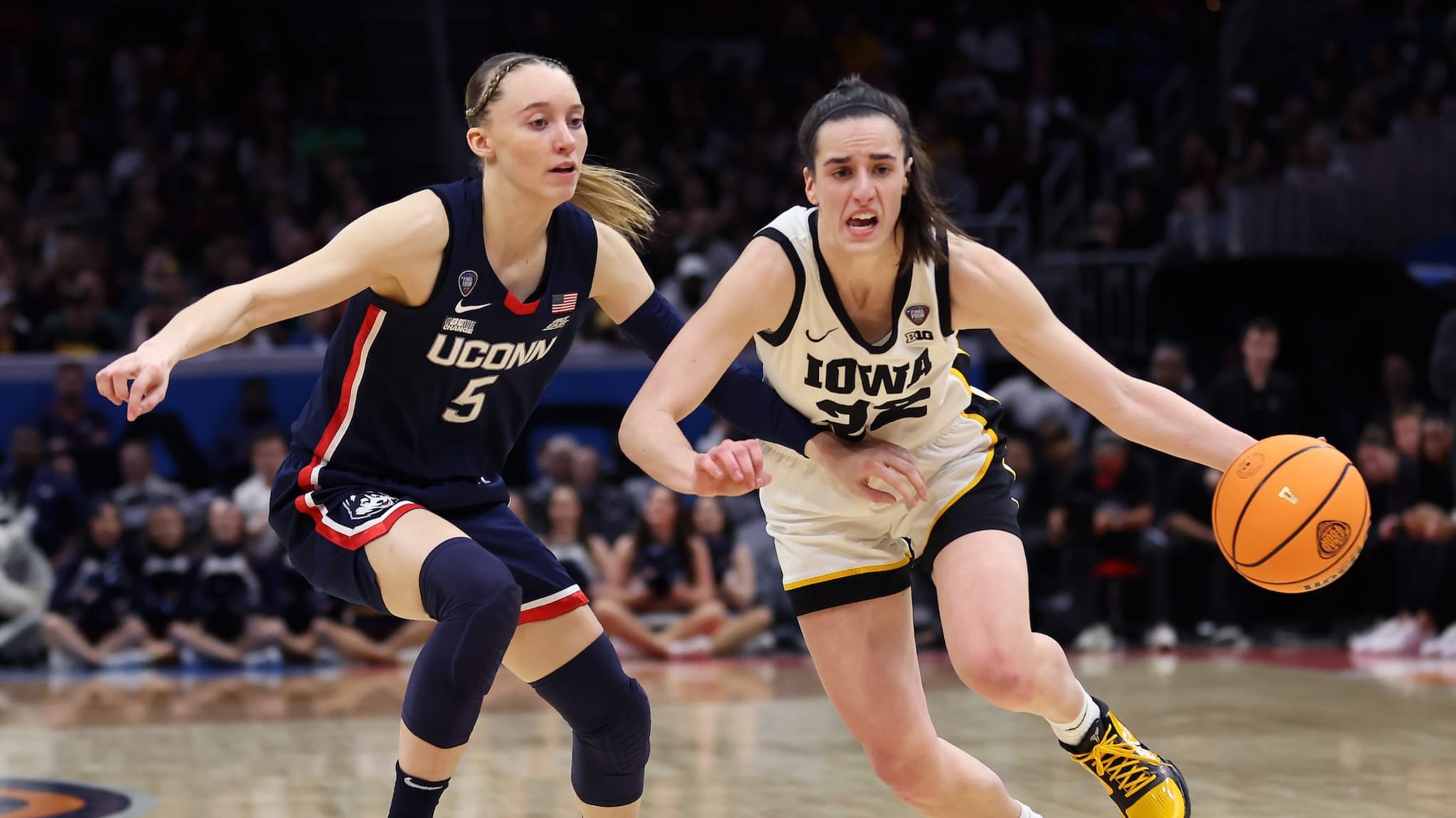 Caitlin Clark #22 of the Iowa Hawkeyes dribbles around Paige Bueckers #5 of the UConn Huskies in the second half during the NCAA Women's Basketball Tournament Final Four semifinal game at Rocket Mortgage Fieldhouse on April 05, 2024 in Cleveland, Ohio.