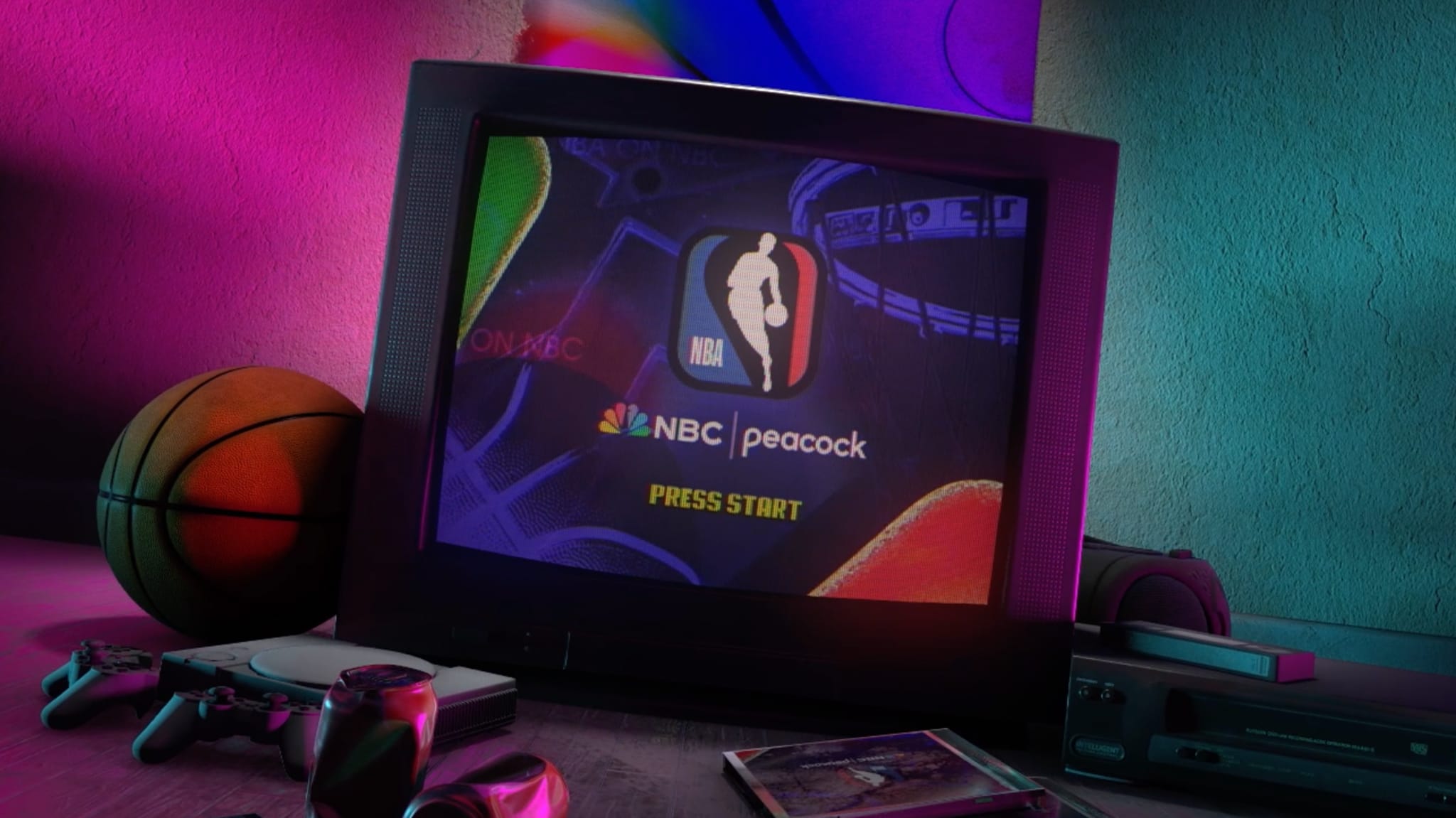 A retro gaming setup with a CRT TV displaying an NBA game screen, surrounded by a basketball, game controllers, and colorful lighting.