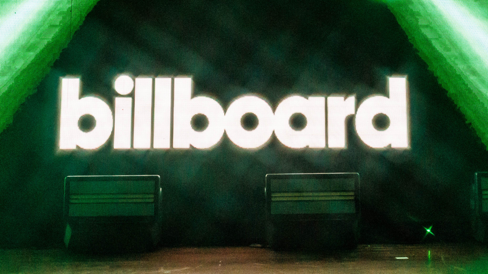 The image shows the "billboard" logo in bright white letters on a dark background, surrounded by green lighting effects.