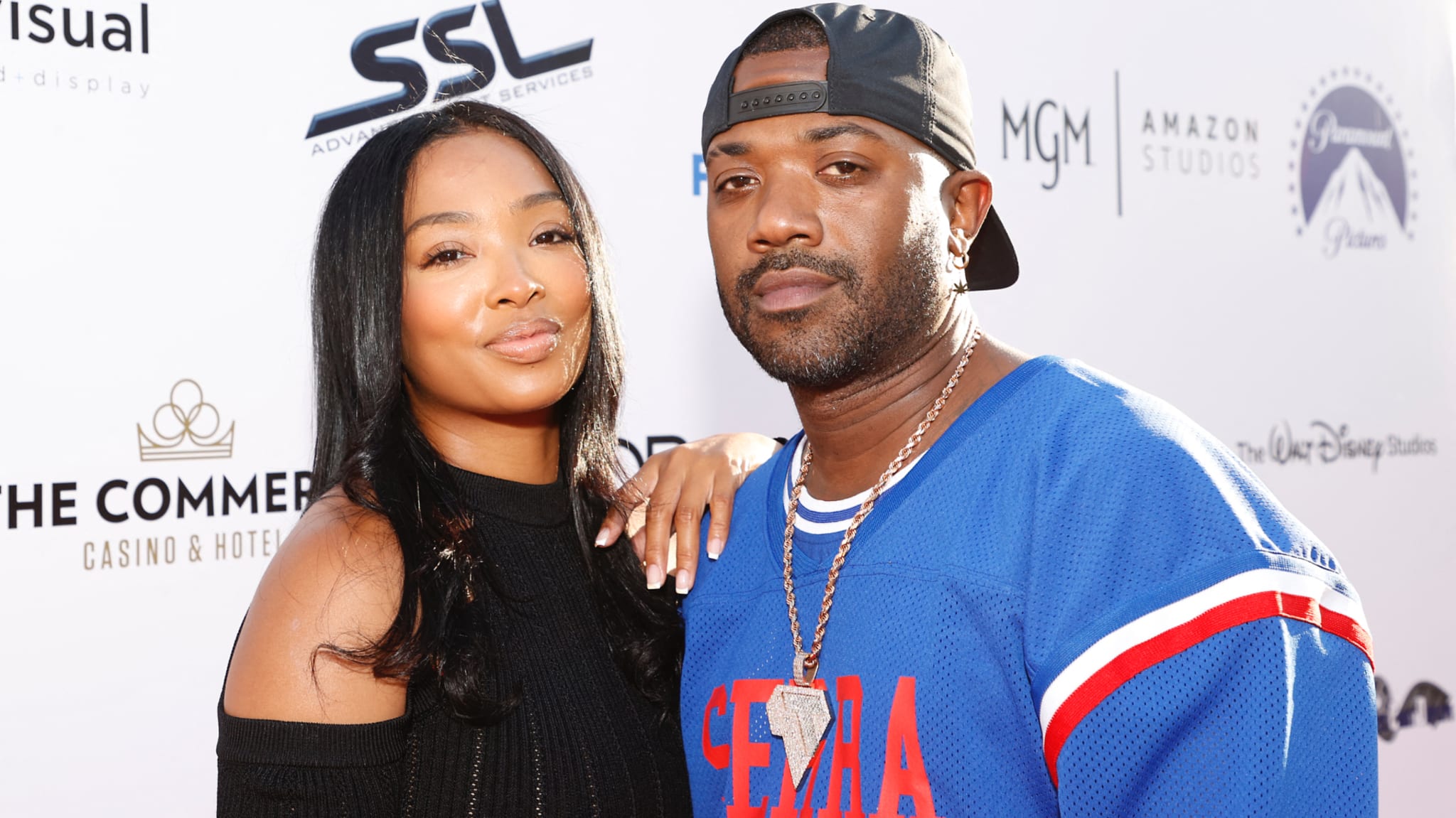 Ray J wears a blue jersey and cap, Princess Love a black top.