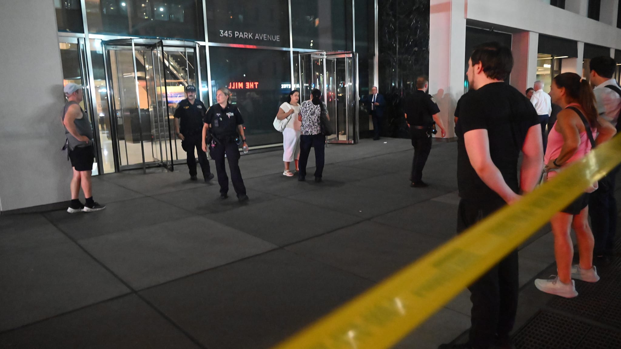 People who sheltered in place exit the building to reunite with loved ones following an attack where five people were shot with four people including NYPD police officer Didarul Islam who was killed in a mass shooting at 345 Park Avenue by suspect Shane Tamura armed with an assault rifle in New York City, United States on July 28, 2025.
