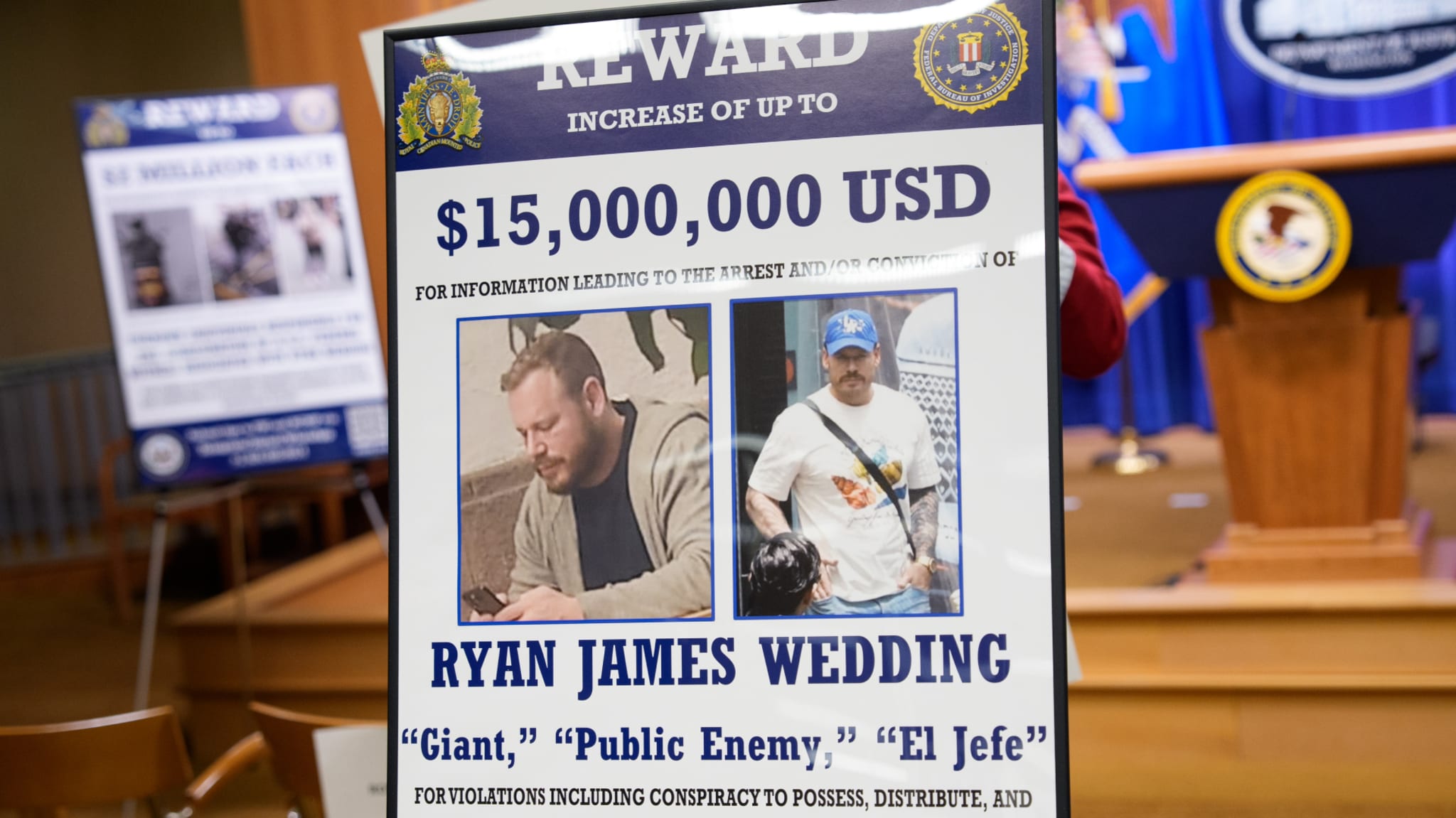 A reward poster offering $15 million for Ryan James Wedding, with images of him and aliases like "Giant" and "El Jefe."