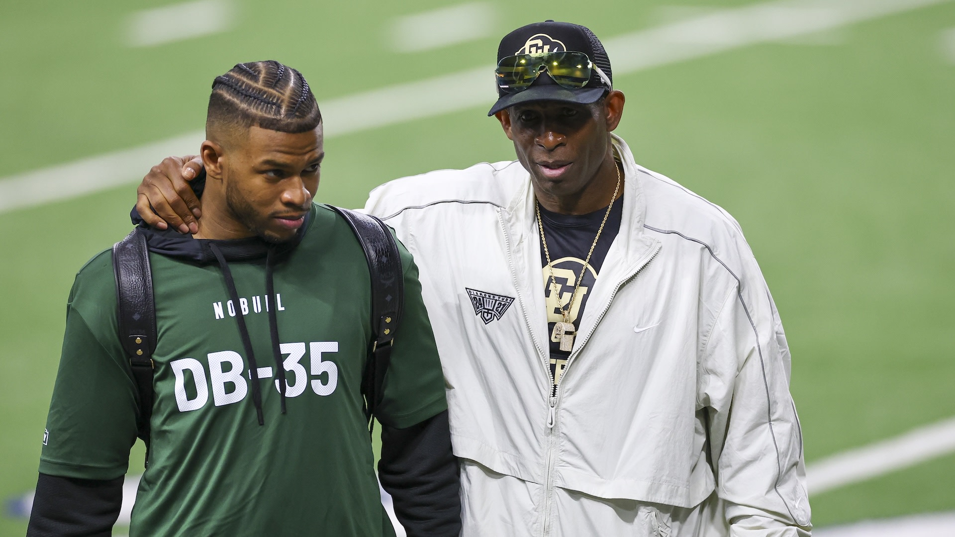 FRISCO, TEXAS - MARCH 20: Head coach Deion Sanders of the Colorado Buffaloes talks with Shilo Sanders of the Colorado Buffaloes on the sideline during the Big 12 NFL Pro Day at Ford Center at The Star on March 20, 2025 in Frisco, Texas.