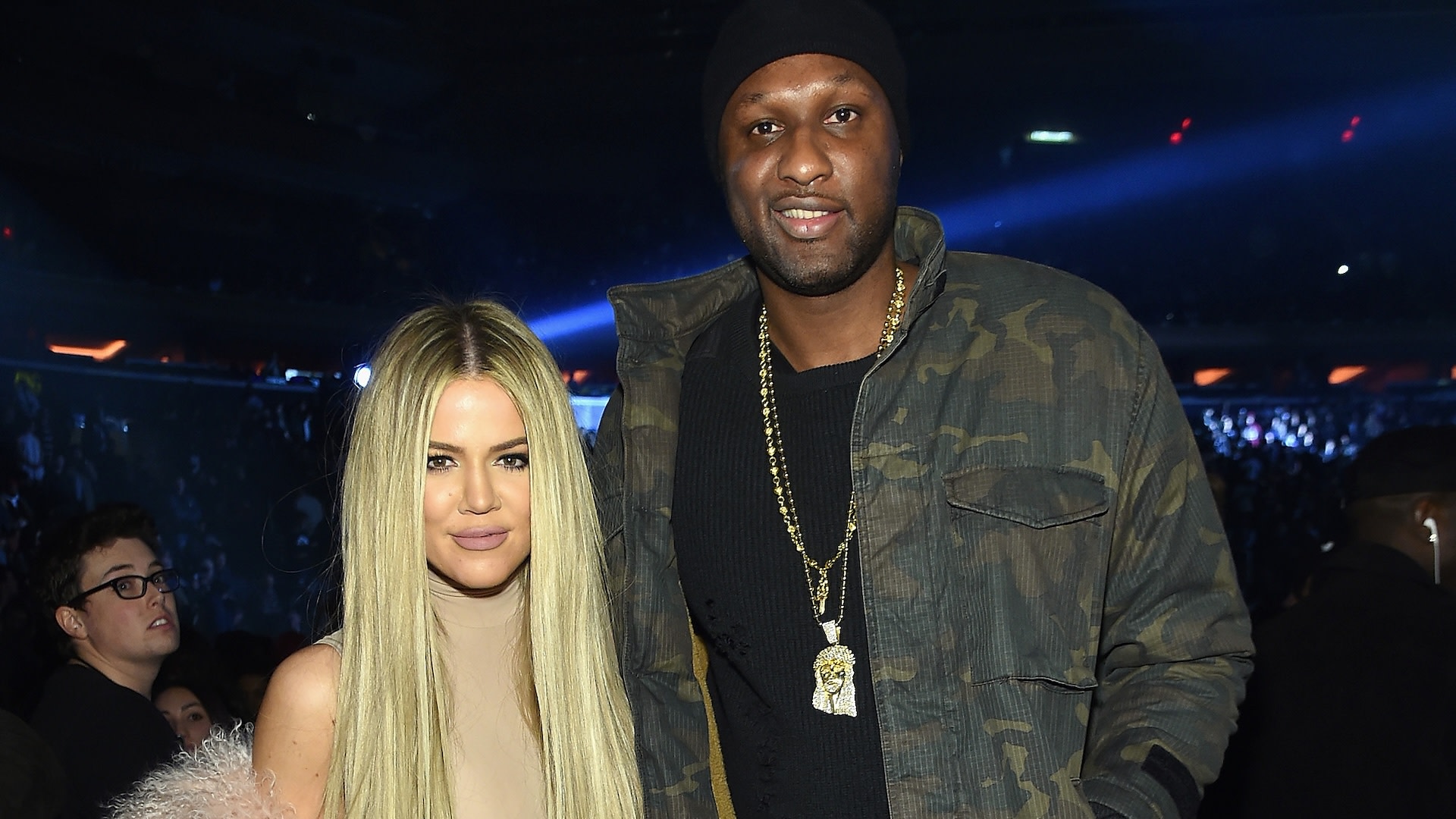 Khloé Kardashian and Lamar Odom at an event. Khloé has long blonde hair, and Lamar is wearing a camo jacket and beanie.