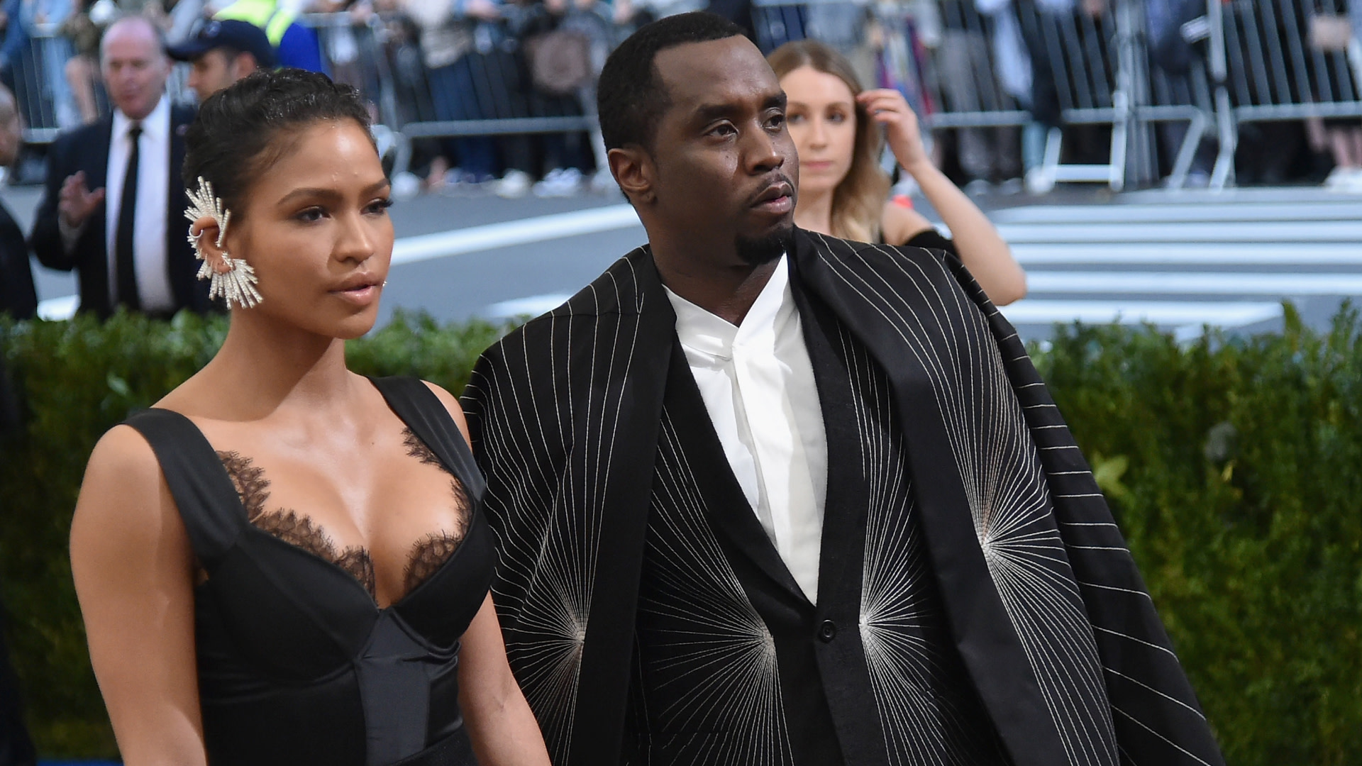 Cassie and Sean "Diddy" Combs at a formal event, with Cassie in a black dress and Diddy in a patterned suit.