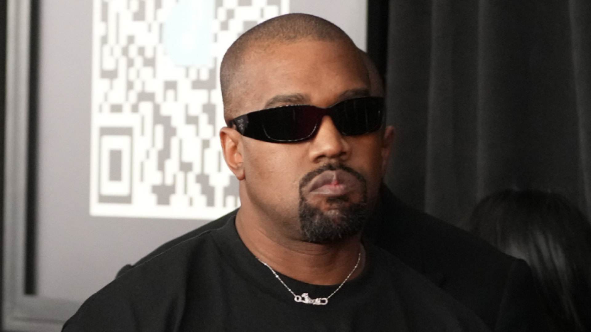 Ye, formerly Kanye West, wearing sunglasses and a black shirt.