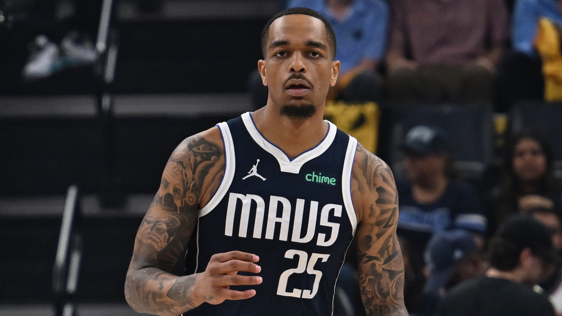 A basketball player in a Dallas Mavericks jersey with number 25, on the court, focused during a game.