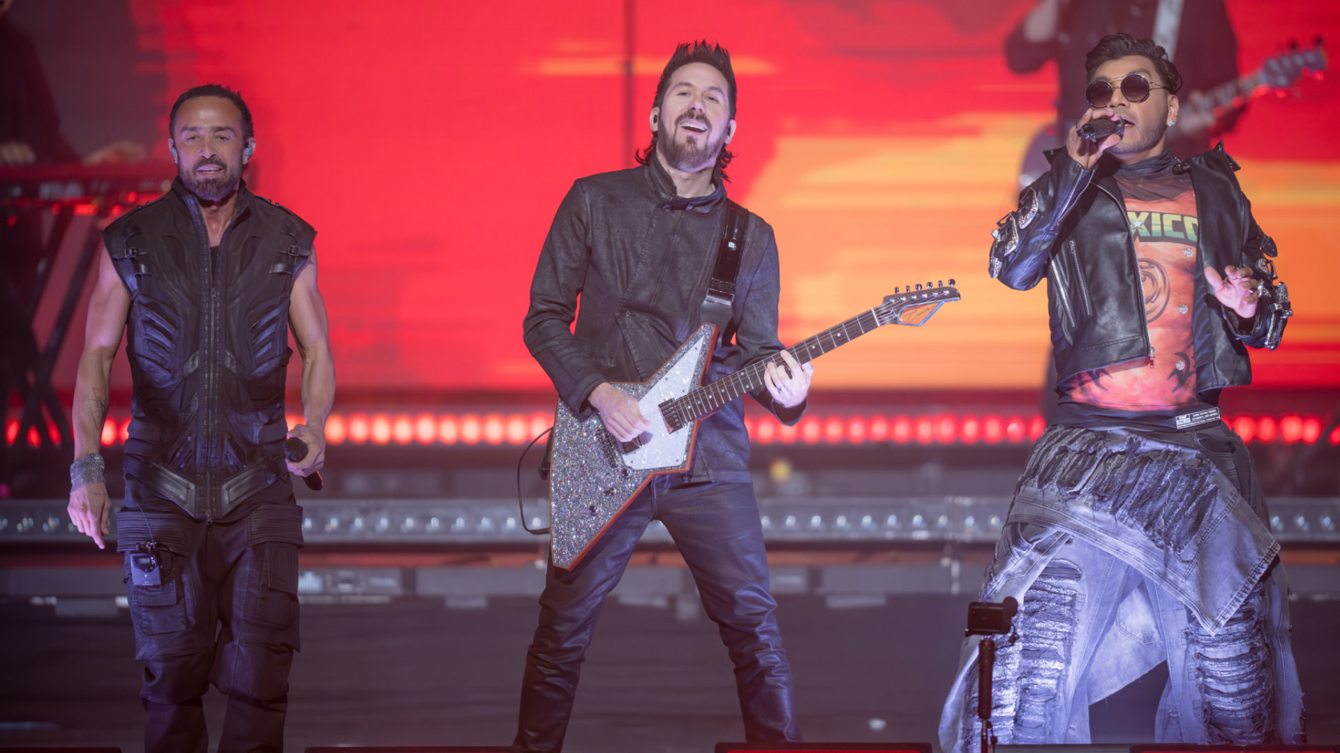 Mario Domm, Pablo Hurtado, and Samo of Camila perform onstage during the 'Regresa Tour' at Smart Financial Centre on February 26, 2026 in Sugar Land, Texas. They are wearing stylish, edgy outfits.