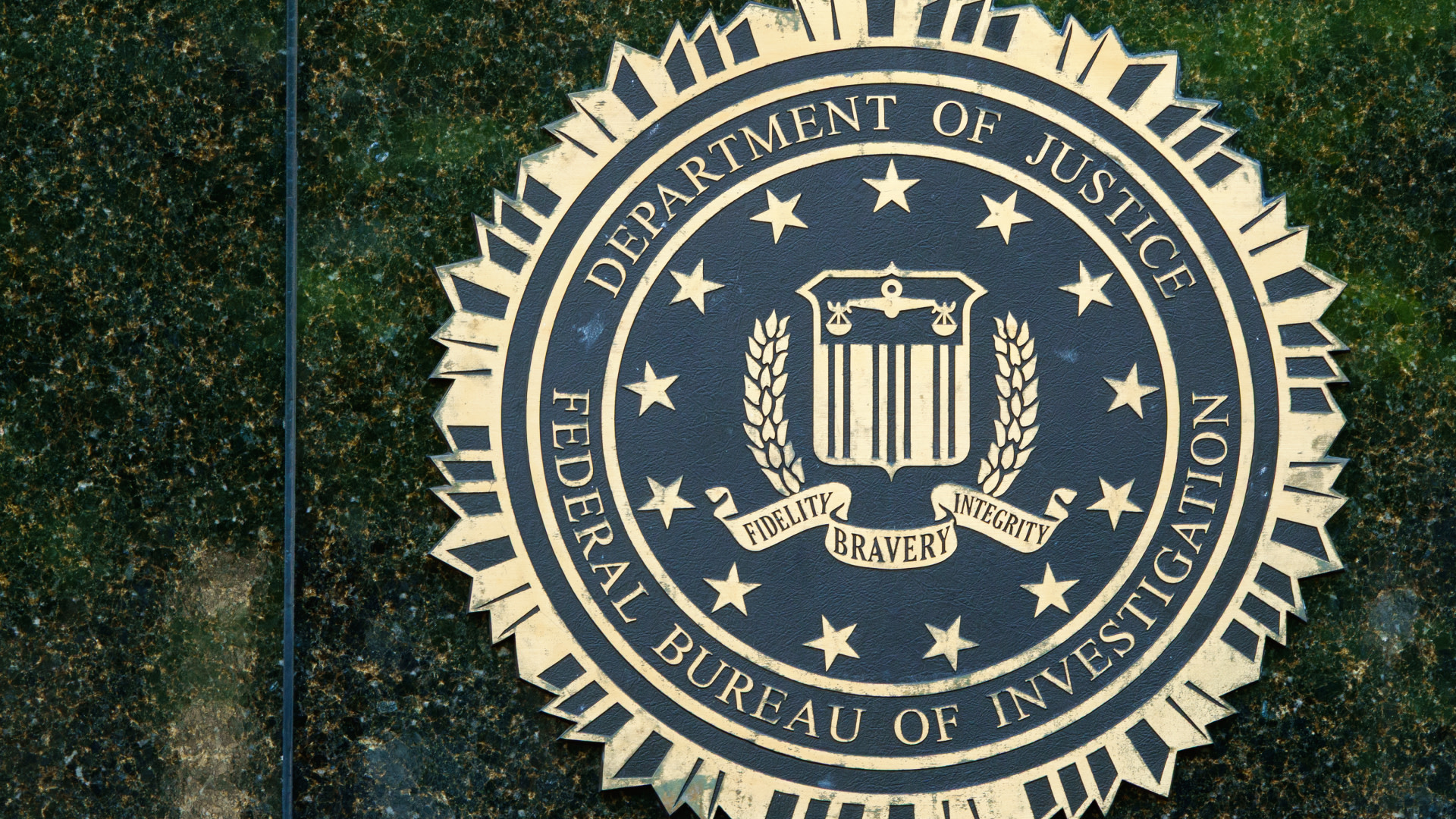 Seal of the Federal Bureau of Investigation (FBI) featuring the Department of Justice emblem with the words "Fidelity, Bravery, Integrity."