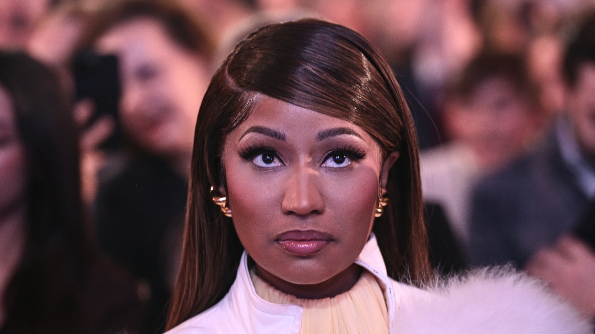 Nicki Minaj looks on as US President Donald Trump speaks about 'Trump Accounts.'
