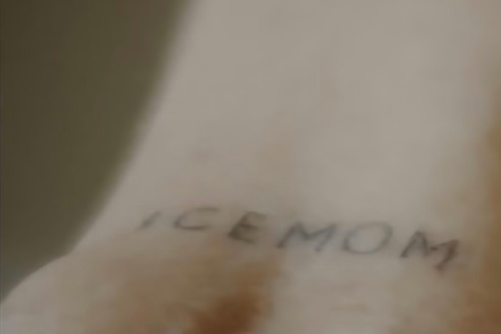 A close-up of a hand with a faint tattoo. Another image shows a tattoo reading "ICEMOM" on skin.
