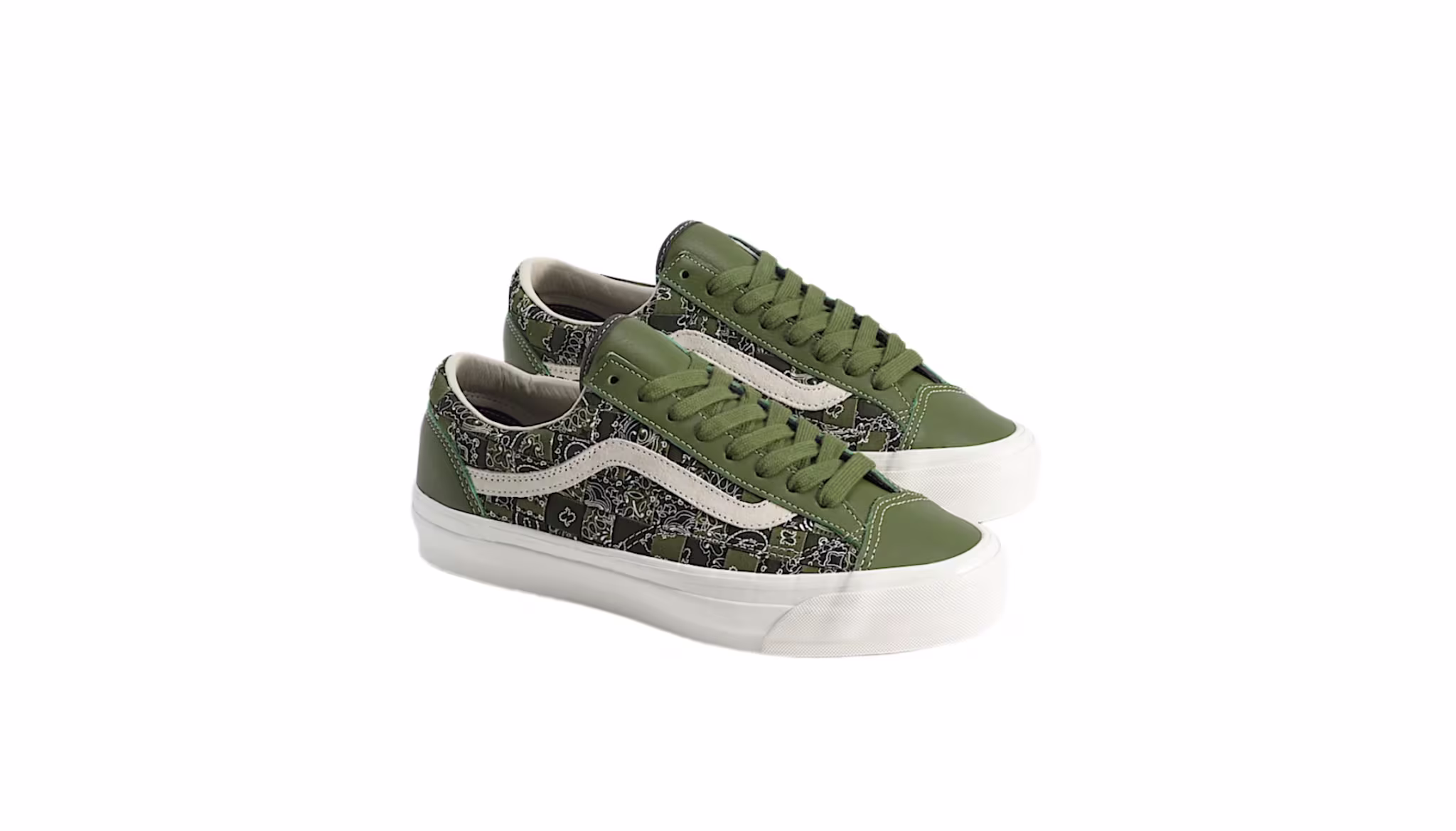 Green and black sneakers with white soles and a patterned design, featuring a white side stripe.