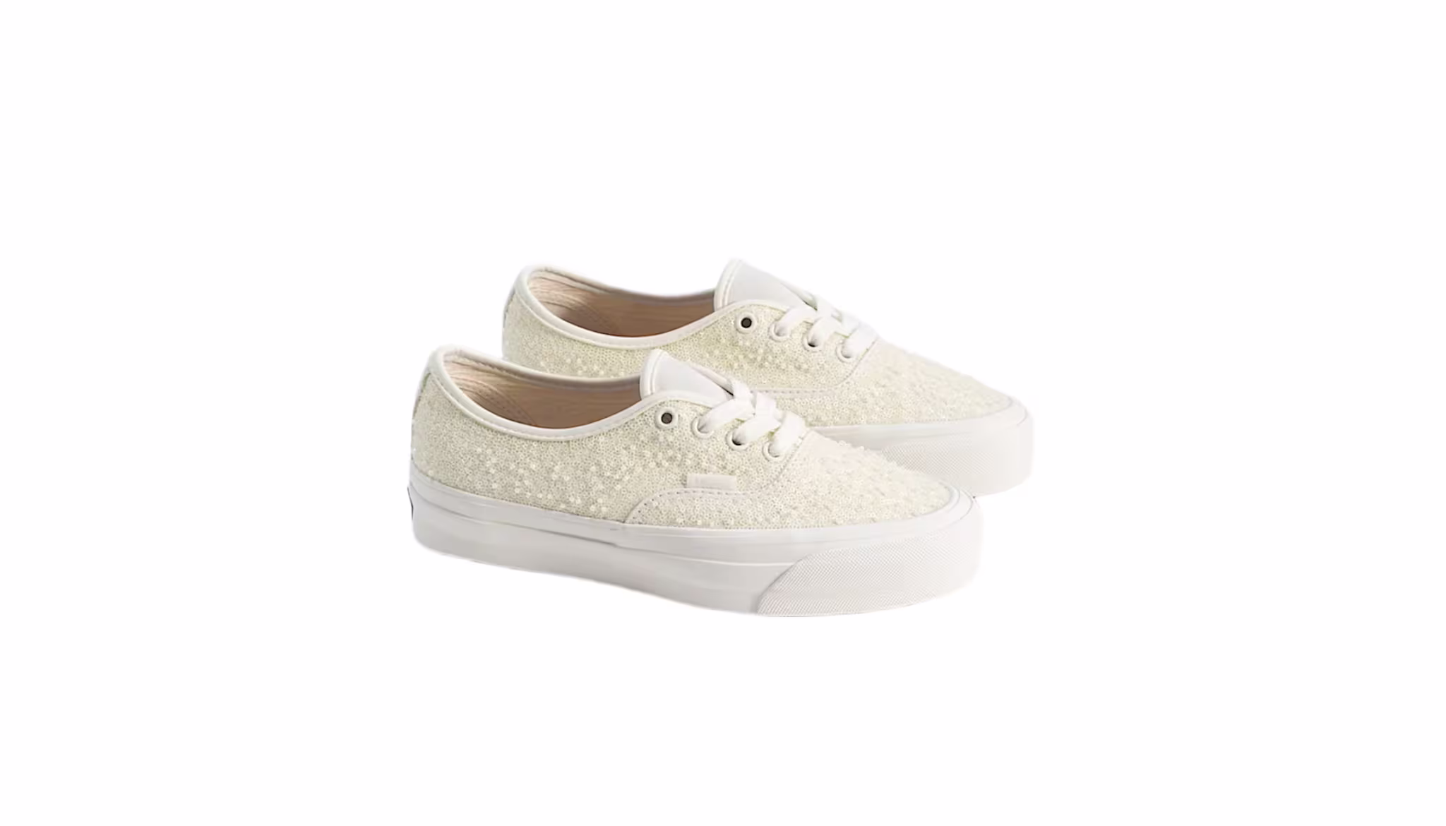 A pair of off-white lace sneakers with white laces and rubber soles, viewed from a slight angle.