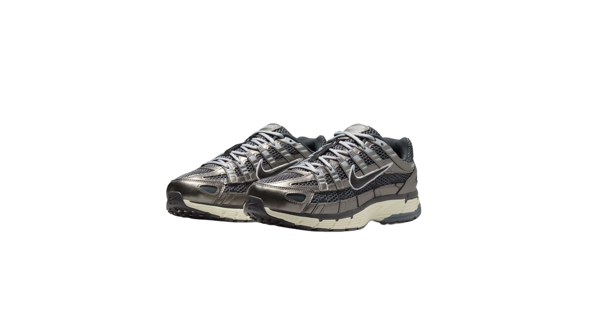 A pair of metallic silver and black Nike sneakers with a beige sole, featuring a mesh design and the iconic Nike swoosh.