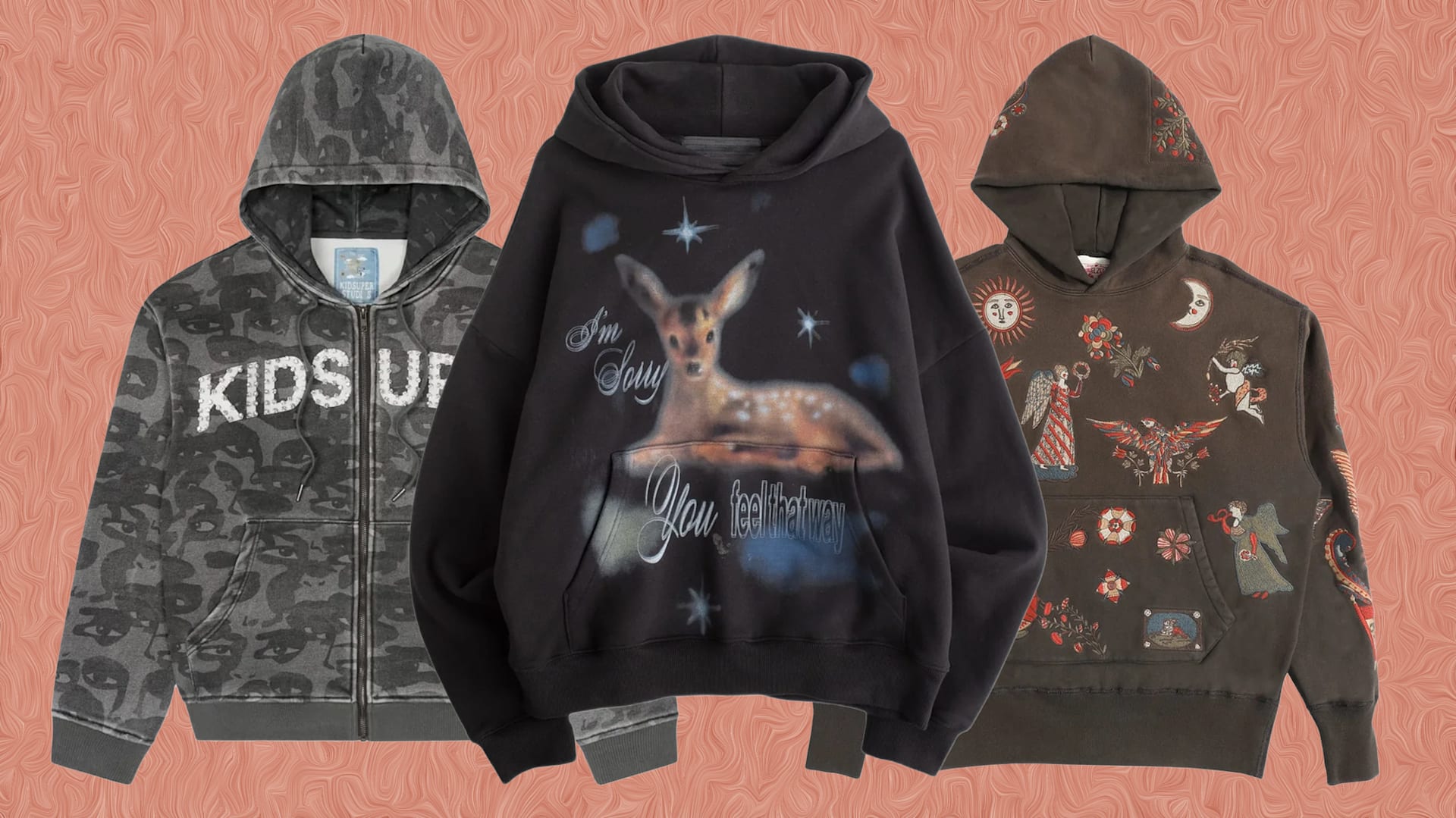 Three hoodies displayed against a patterned background: one gray with "KIDS UP," one black with a deer and text, and one brown with intricate designs.