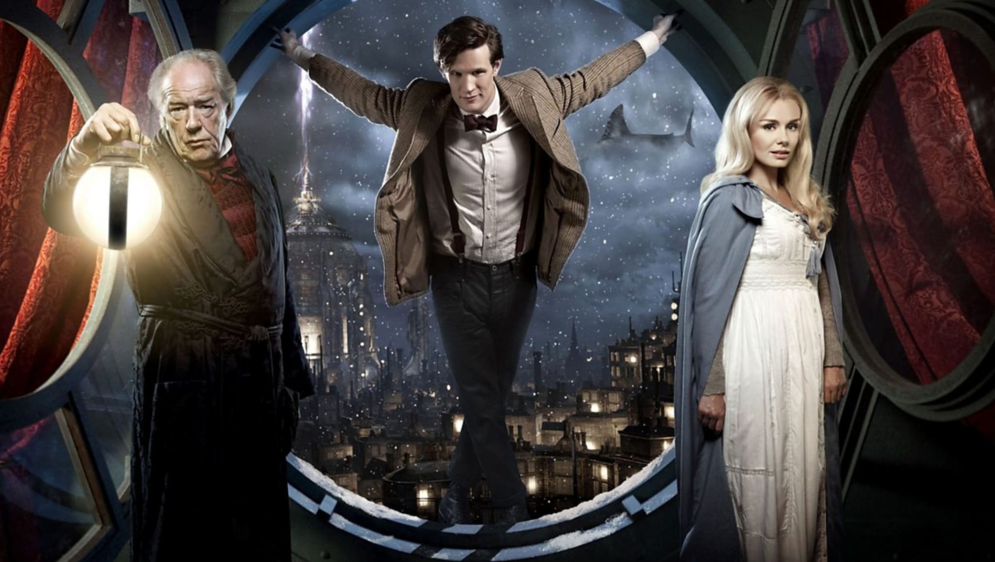 Michael Gambon, Matt Smith, and Katherine Jenkins in a 'Doctor Who' scene with a cityscape backdrop.