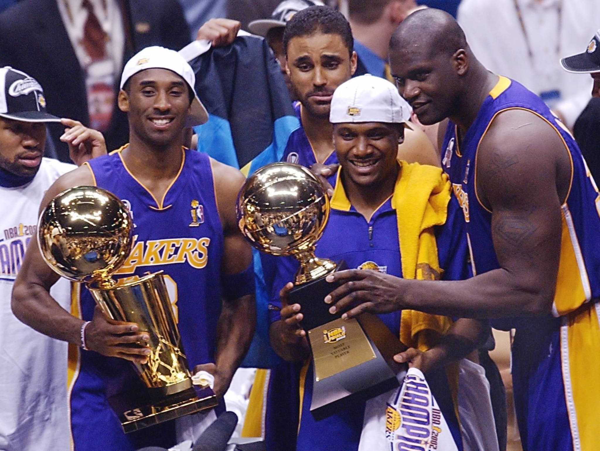 Kobe Bryant, Rick Fox, Lindsey Hunter, and Shaquille O'Neal celebrate the Lakers third consecutive title in June 2002. 