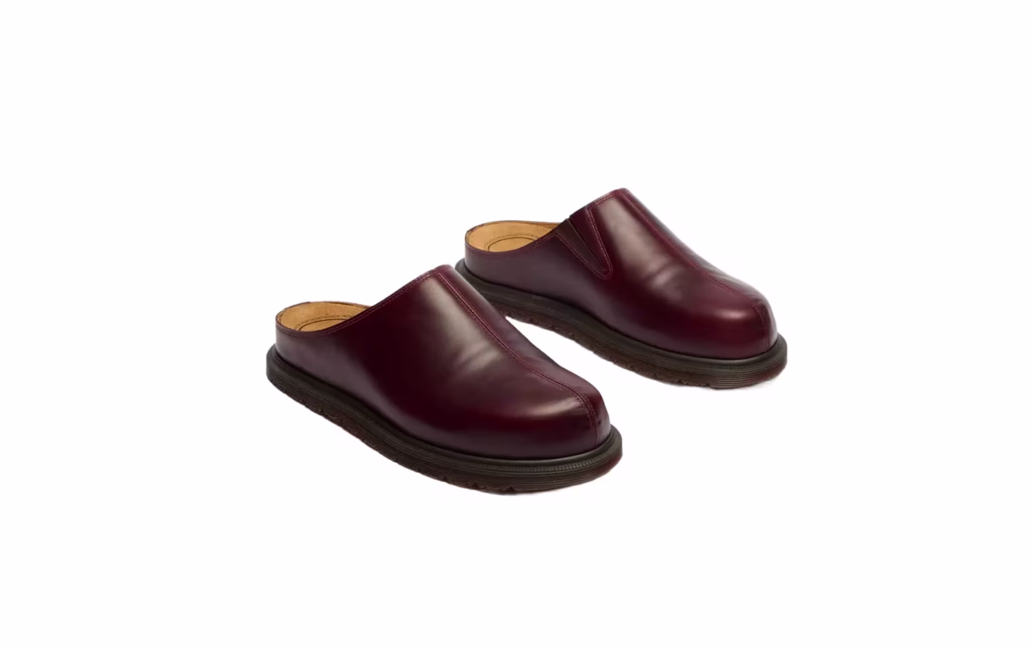Maroon leather slip-on clogs with black soles, viewed from an angle.