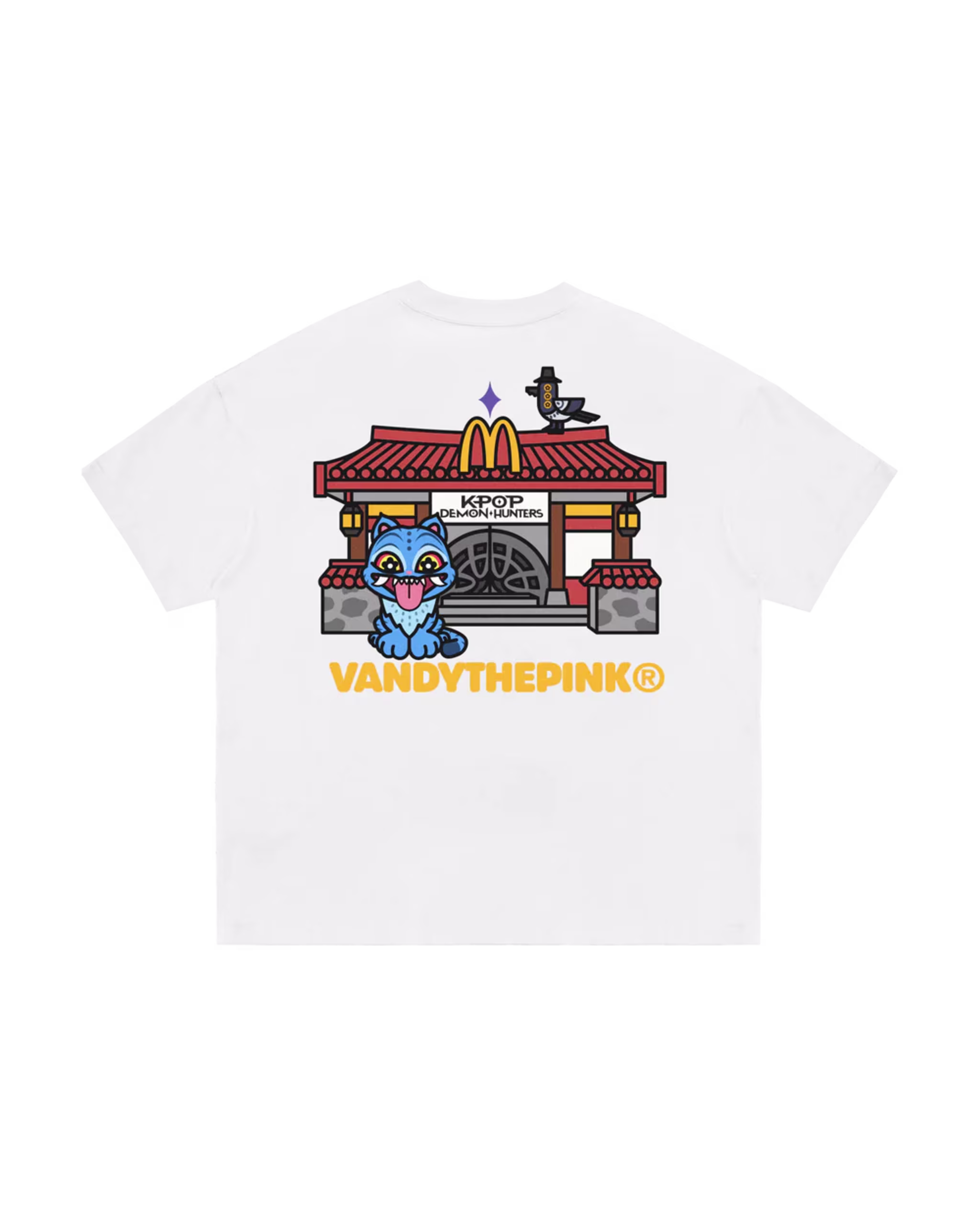 A white T-shirt featuring a cartoon blue cat, an Asian-style building with a McDonald's logo, and "VANDYTHEPINK®" text.